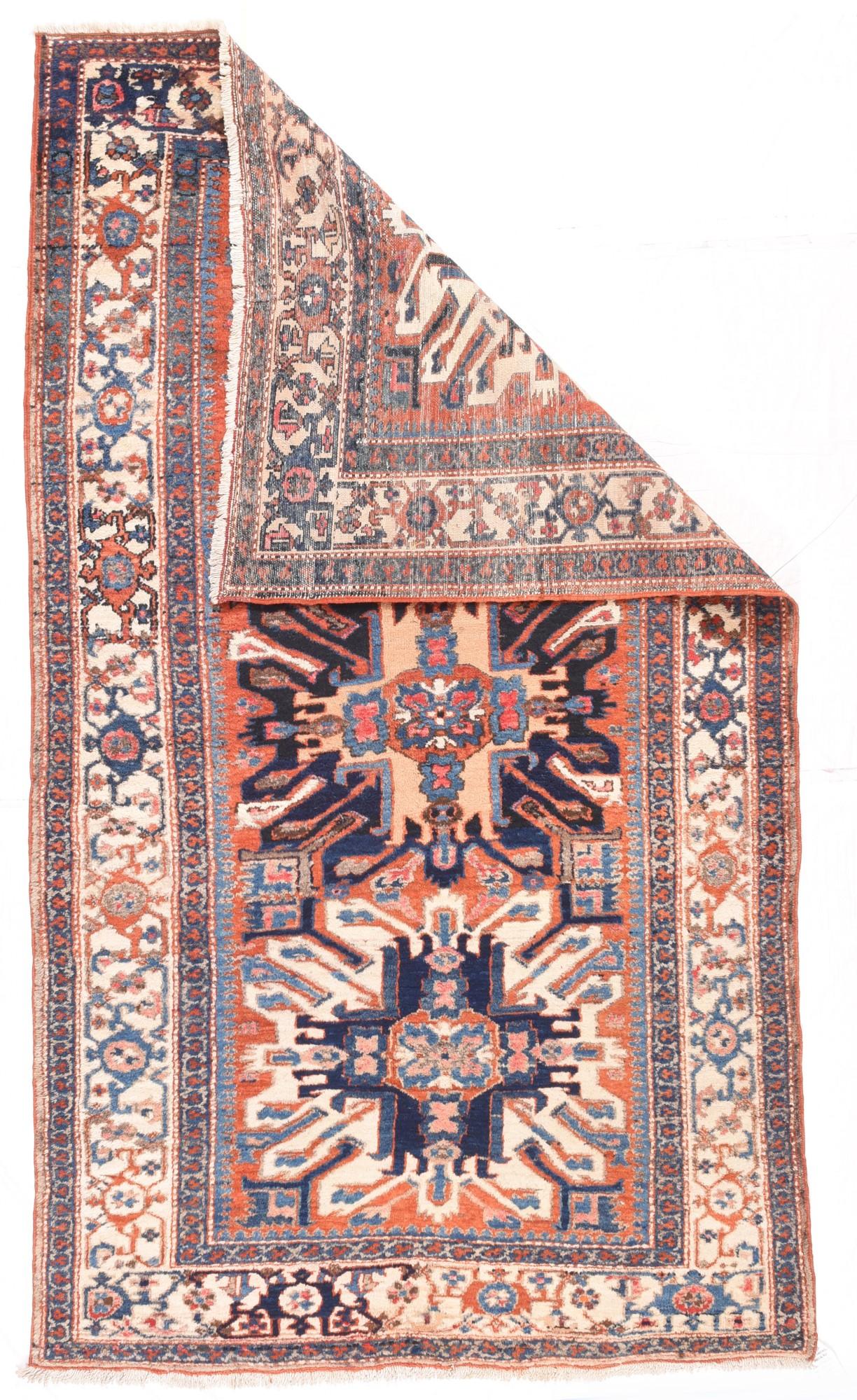 The rust madder4 field displays three “Eagle Kazak” medallions in navy and ecru. Often Caucasian Karabaghs (“Kazaks”) did not come in the appropriate sizes or colourways and the weavers in the Karaja area within the Heriz district were able to fill