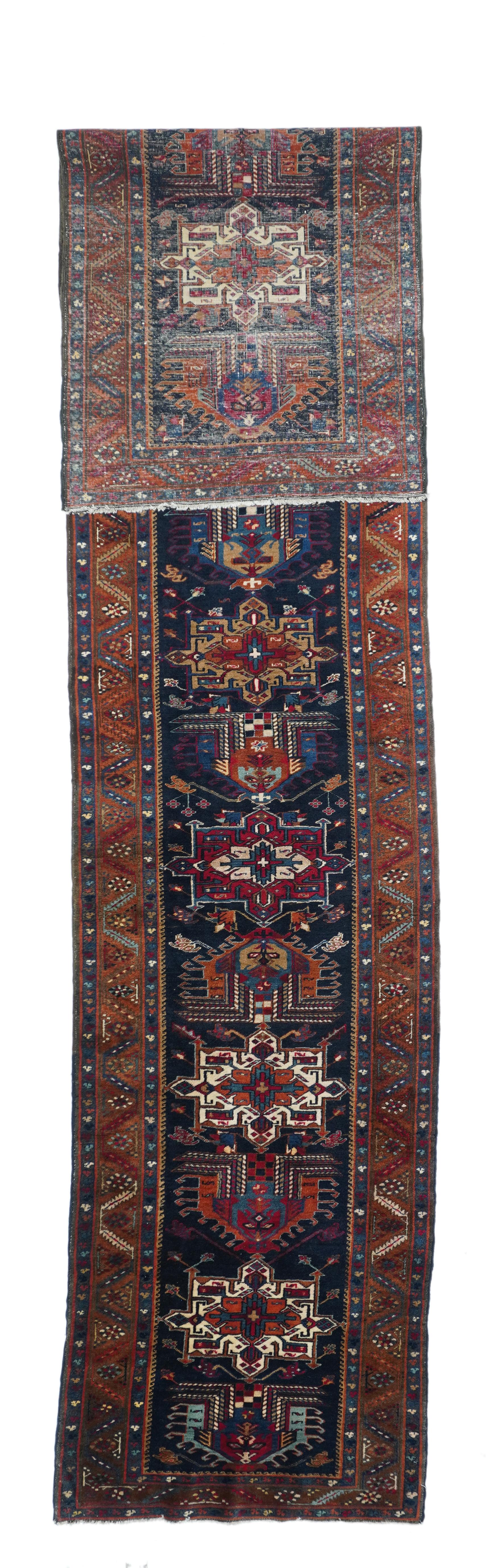 Antique Karajeh Heriz Runner 2'9'' x 14'8''. This narrow, NW Persian runner shows a chain of fifteen characteristic medallions in alternating elaborate palmette and octogramme styles, in red, cream, straw-camel, green and cerulean, all on the navy