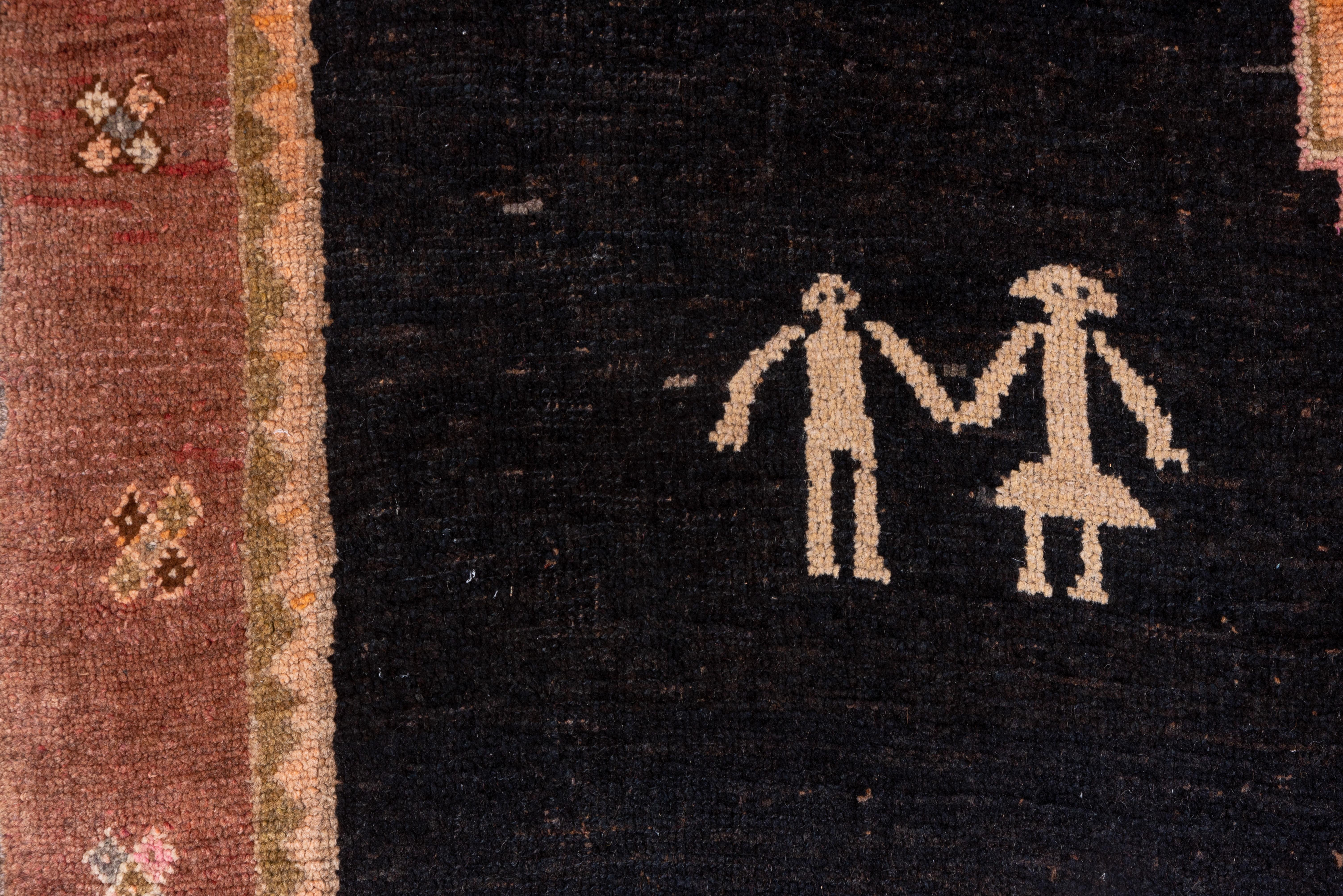 The charcoal field displays a central column of five stepped octagons in straw, rust and pale blue, with widely spaced, flanking chickens and stick figure couples. Salmon main border. Rustic and charming. Good condition.