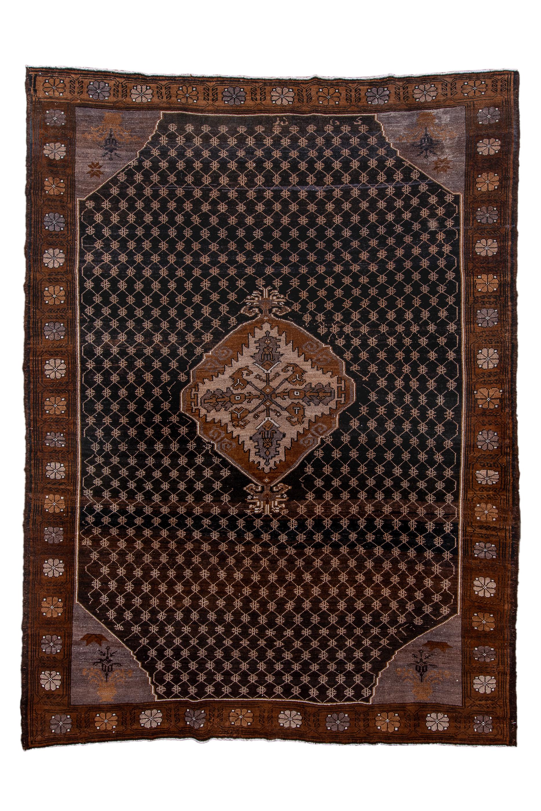 This moderately woven village carpet shows a dark blue field overlaid by a small lattice with small crosses at the vertices and in turn supporting an irregular red and ecru floating medallion with a radiating cruciform blossom central motif.