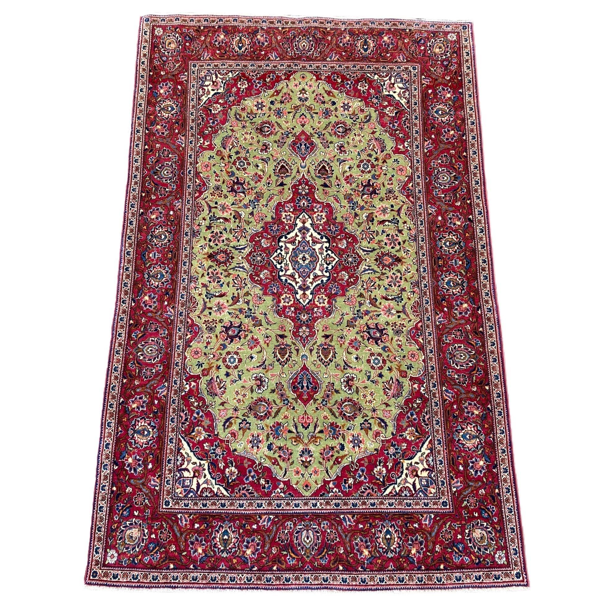 A beautiful antique Kashan rug, hand woven circa 1920 with a classical floral medallion on an unusual green field and red border. Finely woven with lovely wool quality and fabulous secondary colours.
Size: 2.10m x 1.33m (6ft 11in x 4ft 4in)
This rug