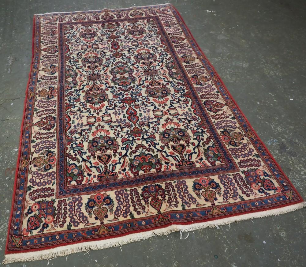 Tapis ancien de Kashan à motifs de fleurs et de vases sur fond ivoire
Circa 1920

Le tapis est de conception traditionnelle Kashan avec un motif sur tout le pourtour de gerbes de fleurs dans un petit vase La bordure principale est également de la