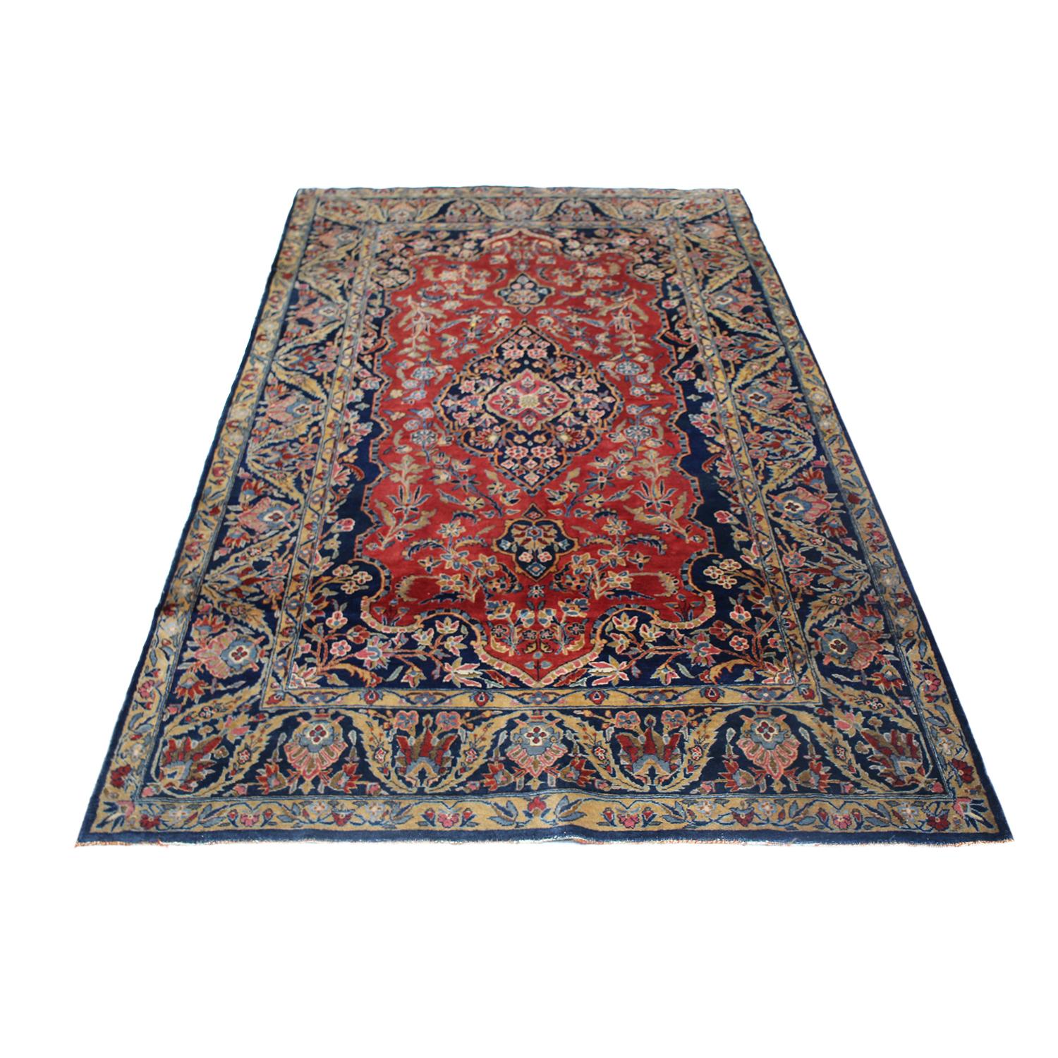 Hand knotted in high-quality wool originating from Persia in 1890, this antique Kashan Persian rug enjoys a particularly uncommon creative depiction of the cypress tree motif in its mirrored wrapping borders, a traditional symbol widely believed to