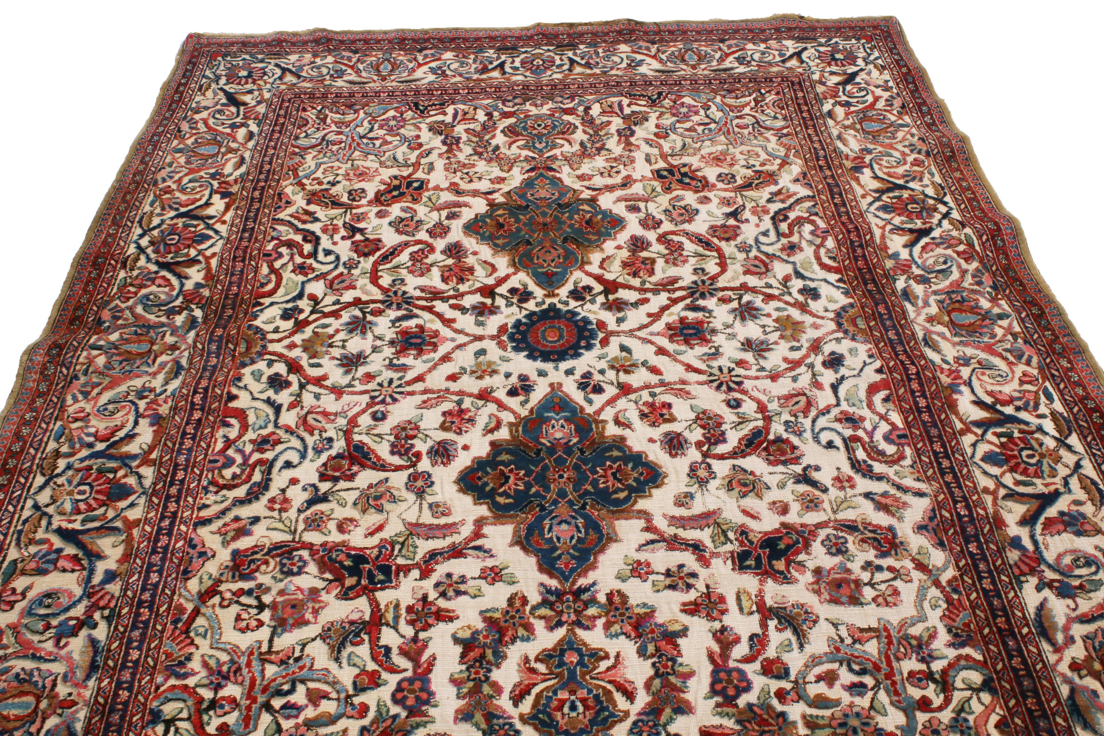 Enjoying pristine, hand knotted silk originating from Persia in 1900, this antique Kashan rug marries the intricacy of traditional lotus flowers and Islmi vine scrolls with an uncommon emphasis on the luminous beige background, accented by the