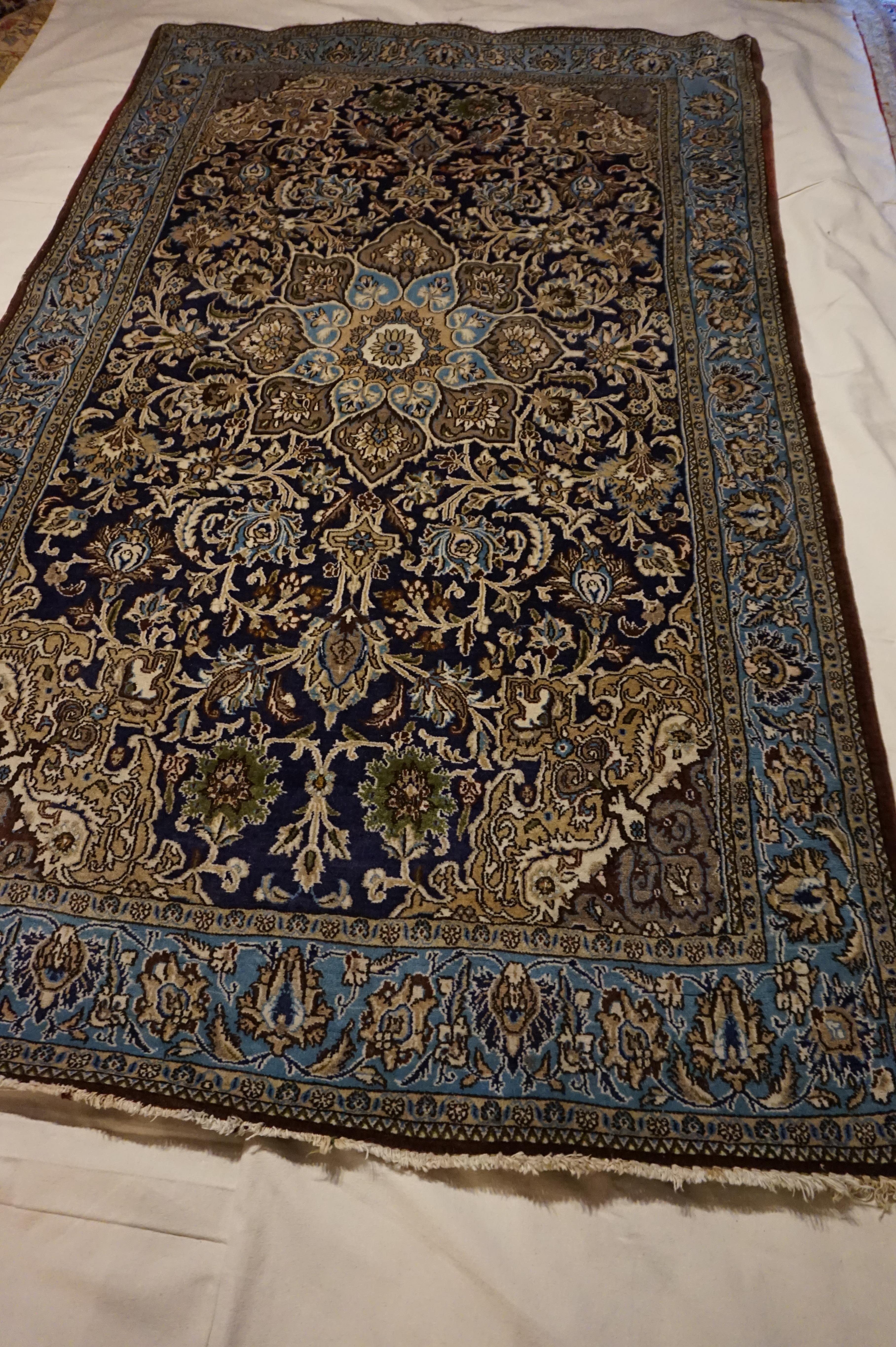 Fine Kashan masterfully hand knotted in Kashmir during British India days. High quality wool and exquisite deep Indigo hues contrasted with browns, sages, turquoise and silvery natural dyes. Good condition for age with predominantly good pile save