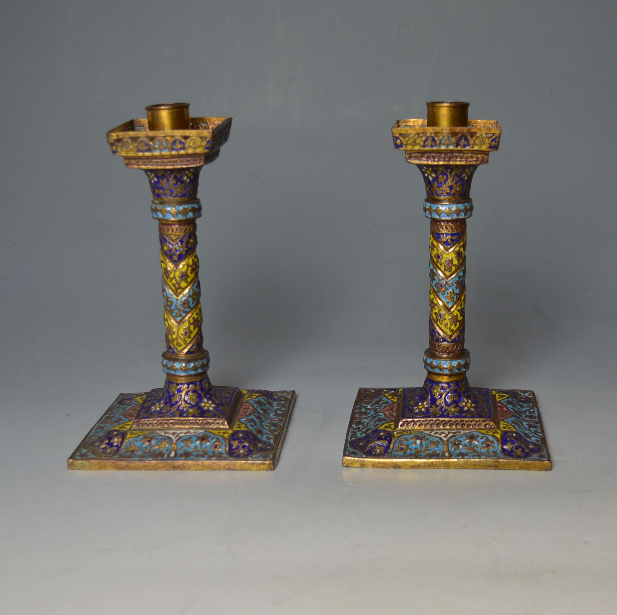 Fine Antique Kashmiri Enamelled gilt copper candle stick holders.
Superb square based candle holders hand crafted from copper and embellished with colourful polychrome floral work enamel design and gold gilt 
Dating from the 19th century, made for