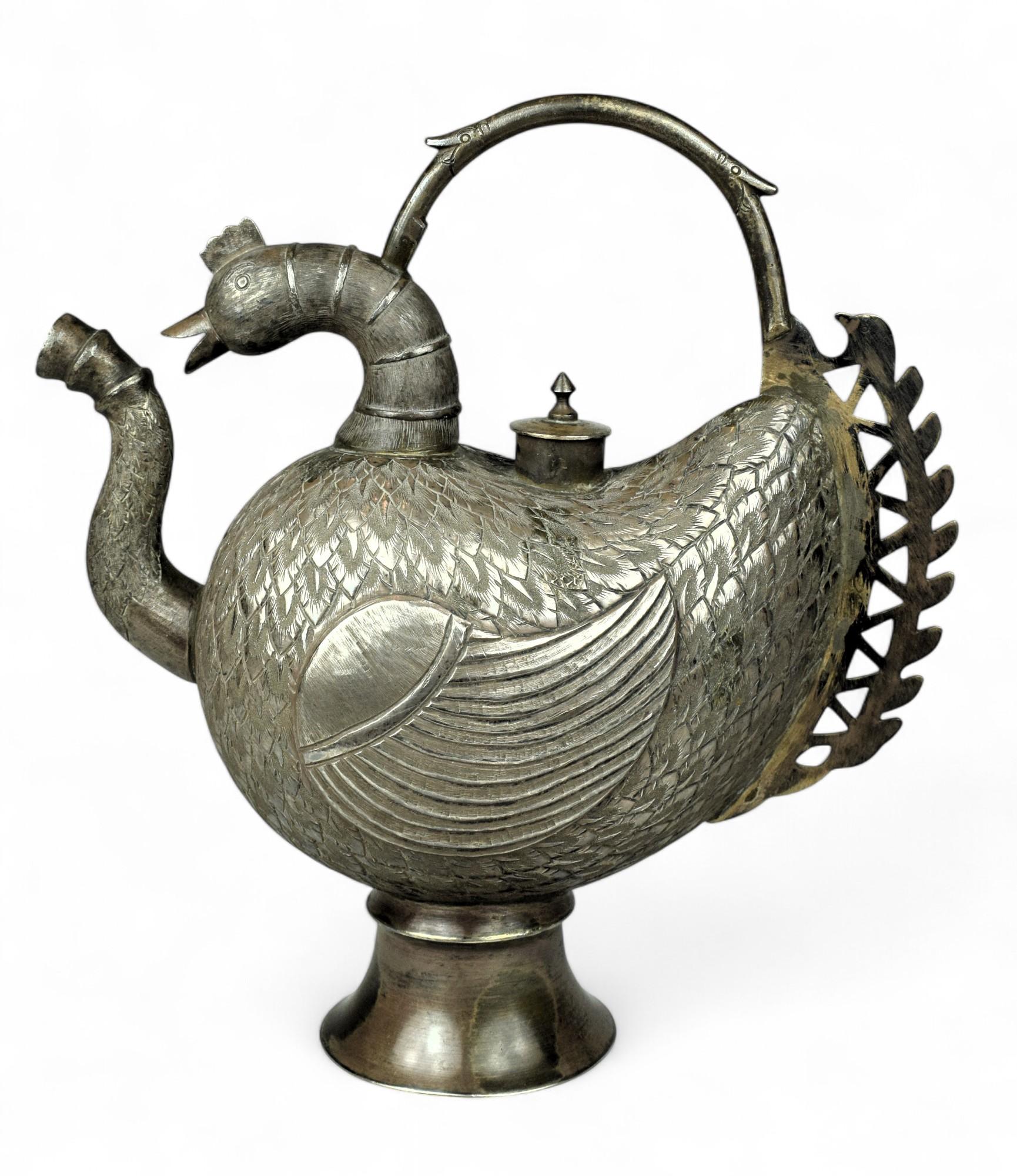 Antique Kashmiri Silver Bird-Shaped Ewer Vessel
Circa early 20th century   Kashmir
Dimensions: Height: 9 in. (23 cm) x Width: 9 in. (23 cm)

A striking and whimsical work of ceremonial silver, this antique Kashmiri ewer is designed in the form of a