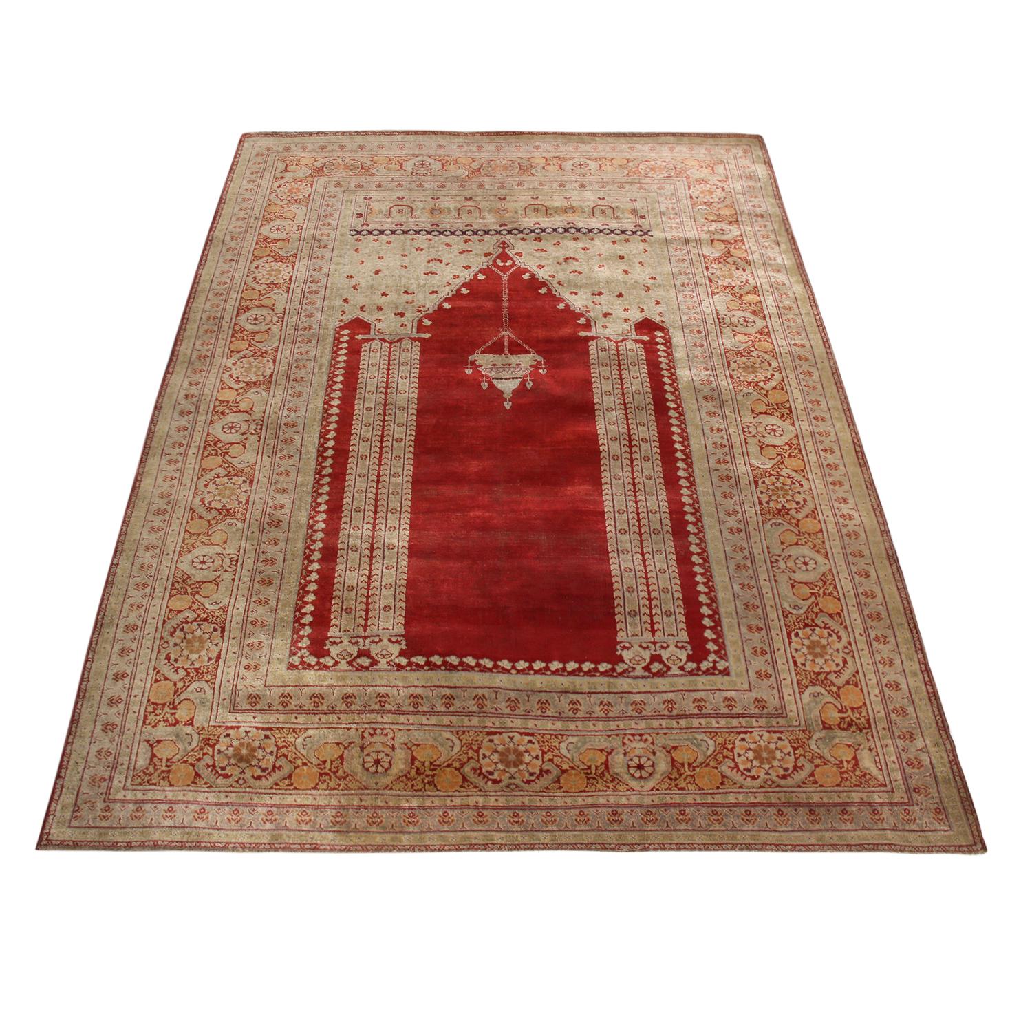 Hand knotted in high-quality wool originating from Turkey between 1880-1890, this antique Kayseri rug enjoys one of the richest abrashed vermillion red field backgrounds, further accented by the sharpness of detail in the chandelier-column motifs