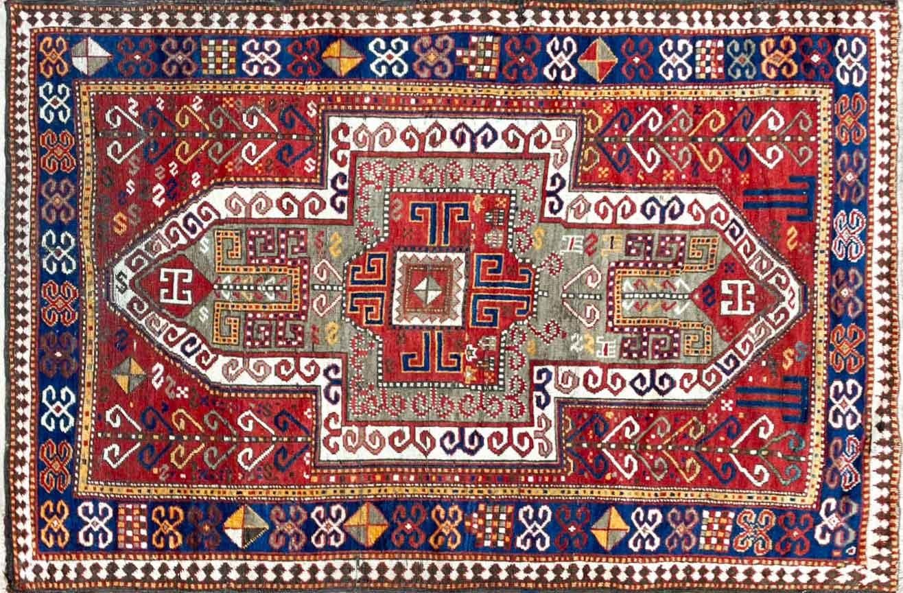 Behold the timeless beauty of our Antique Kazak Rug, a true treasure that dates back to the 1880s. Measuring 4'2