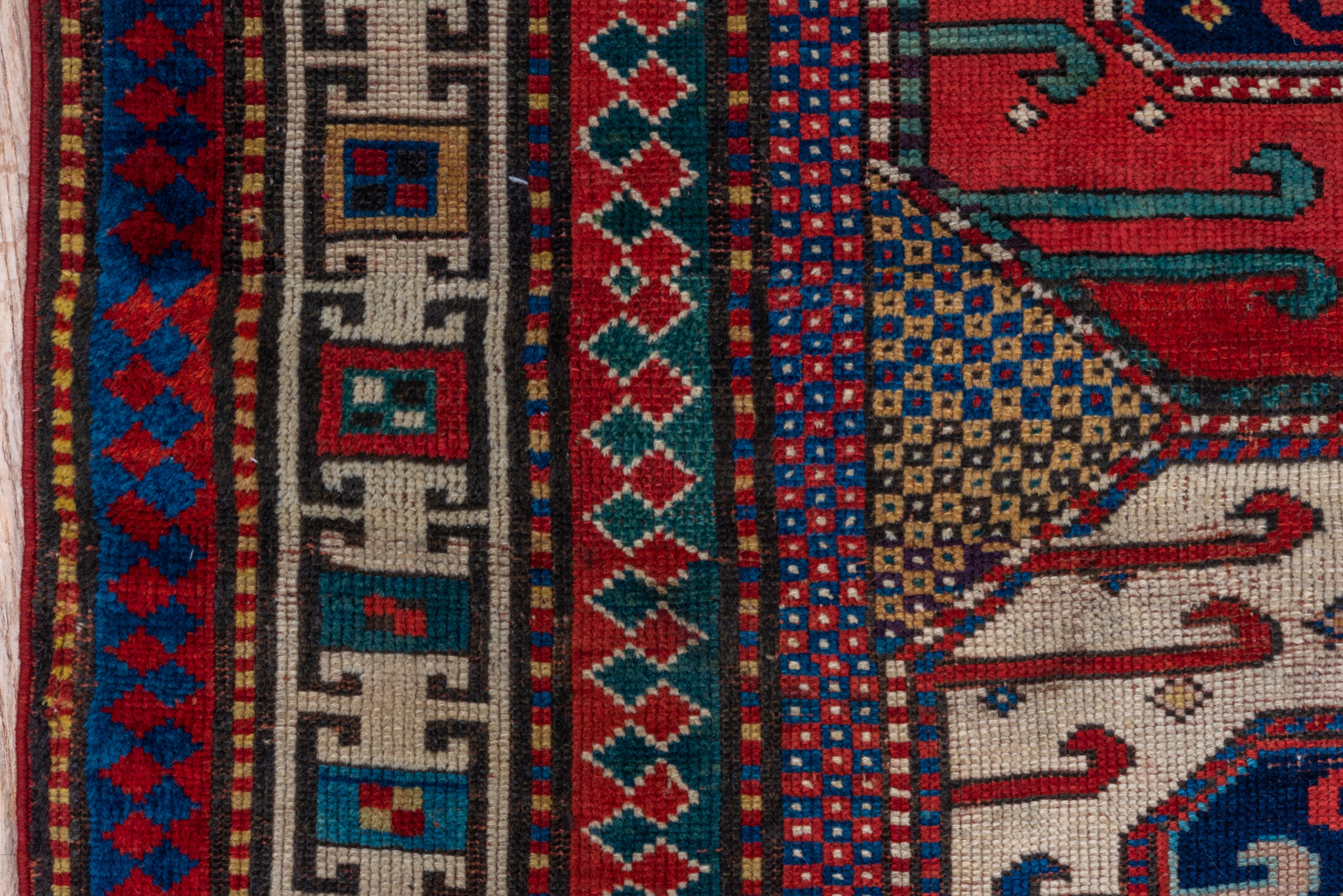 Wool Antique Kazak in Red and Ivory with Tribal Detailing - Circa 1900s For Sale