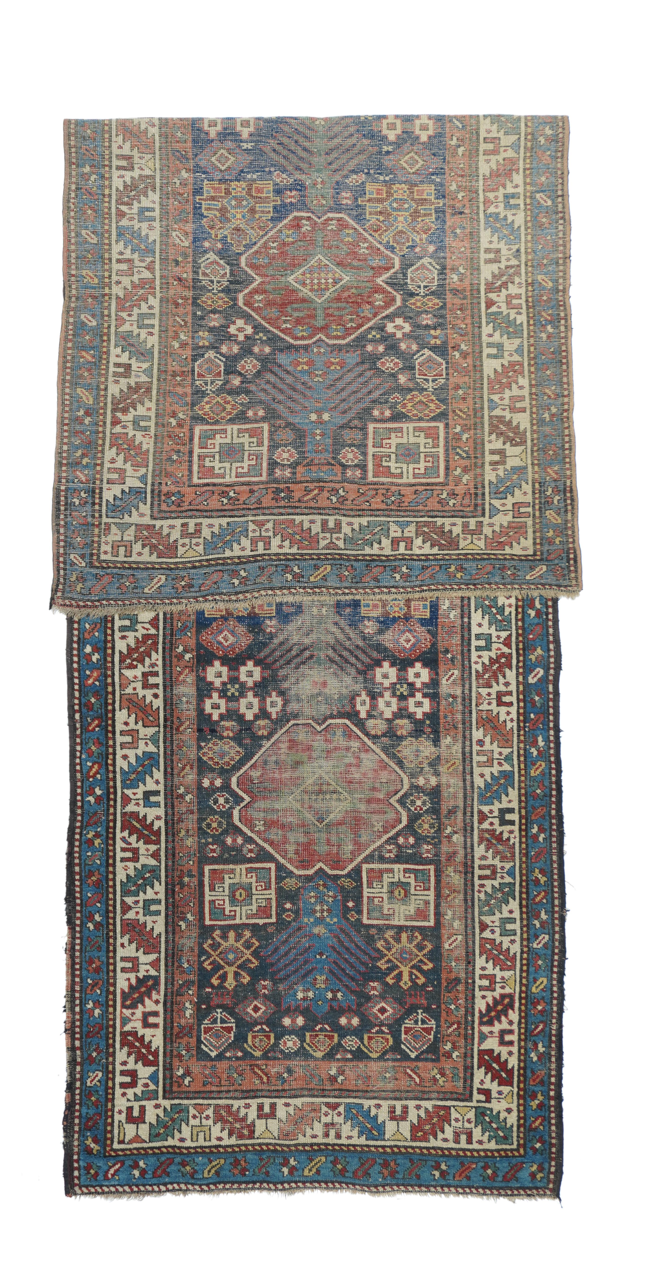 Antique Kazak Rug 3'6'' x 10'9''. East rather than west Caucasian, this sapphire blue ground Kenare (runner) displays four red pinched oval medallions, with secondary Kufesque squares and tertiary geometric ivory flowers. Ecru main border with