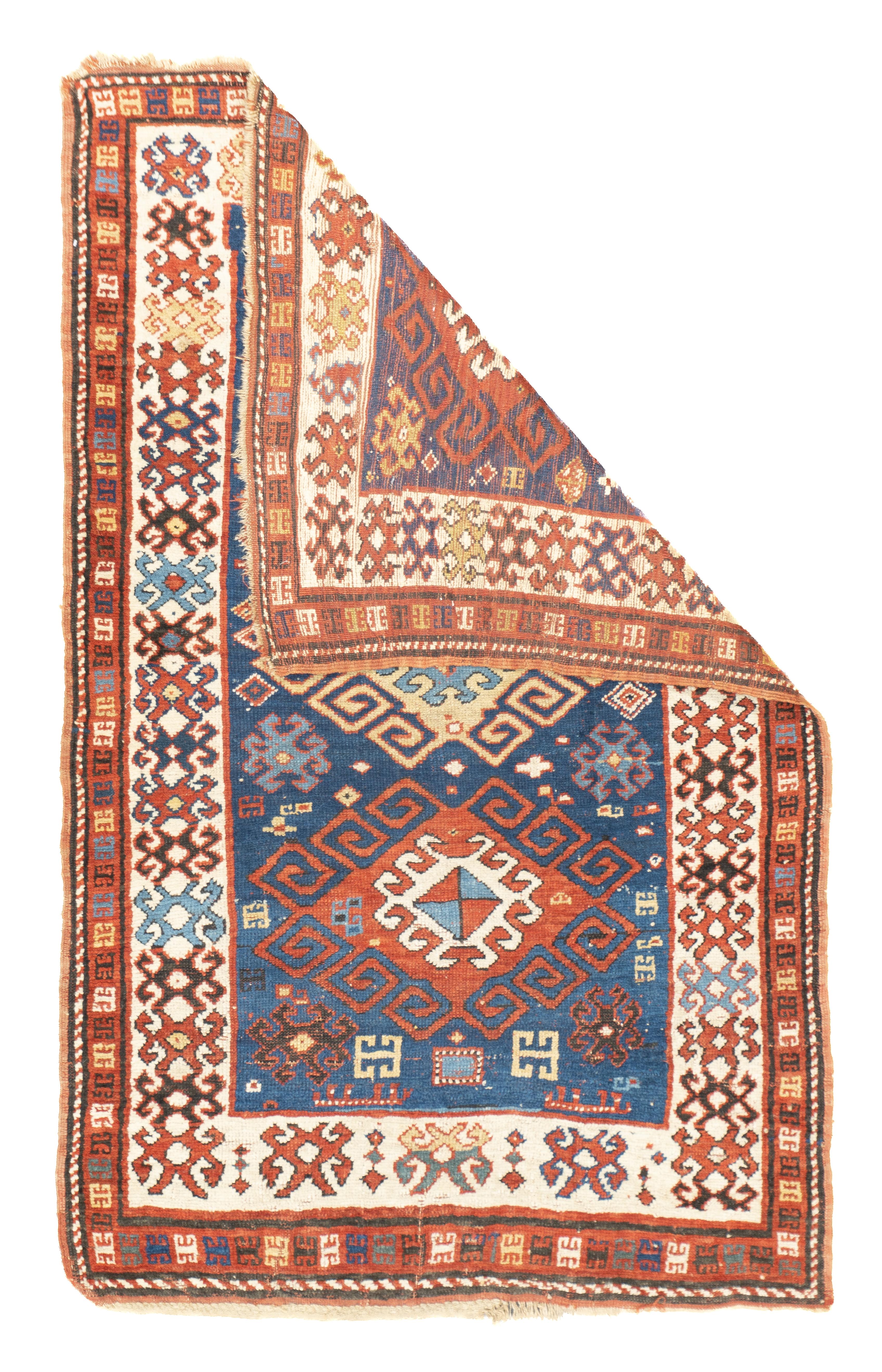 Antique Kazak Rug 3'7'' x 5'6''. The royal blue field of this SW Caucasian scatter shows three nested and hooked lozenges in straw, red and cream; with small supporting octagons, lozenges, cross and hooked elements. Ivory main border of attached or