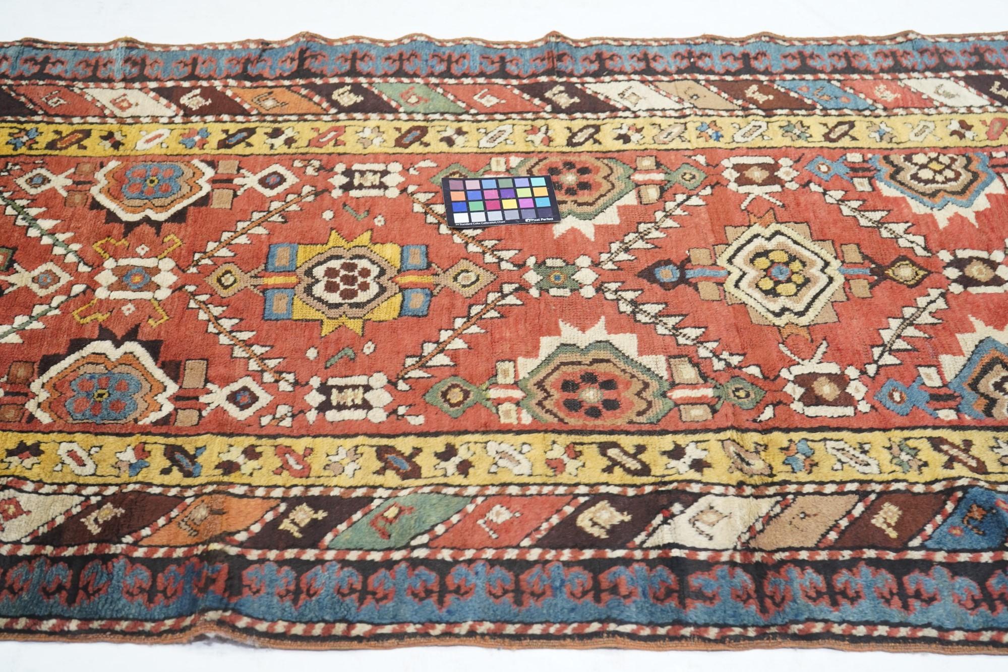 Antique Kazak Rug 3'8'' x 8'1''. With a warm madder red field divided evenly by a doubly stepped lattice into reserves centred by pinched octagonal elements. An allover textile pattern. Color diagonal stripe middle border and bitonal keyhole