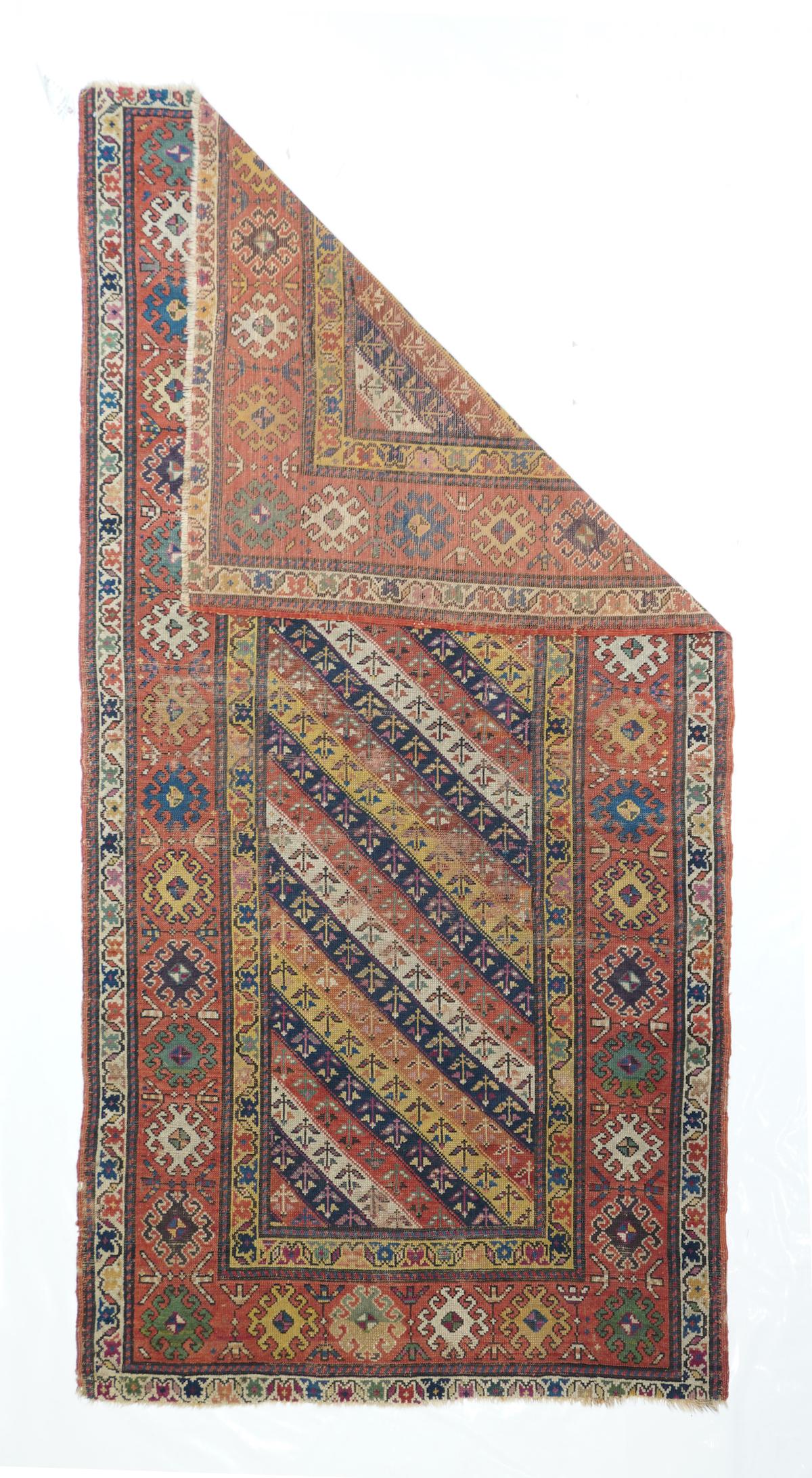 Antique Kazak 3'9'' x 7'7''. From the southern central Caucasus, this all wool kellegi (long rug) displays the characteristic diagonally striped pattern in equal width bands of yellow, rust, red, navy, and cream, all with similar repeating small