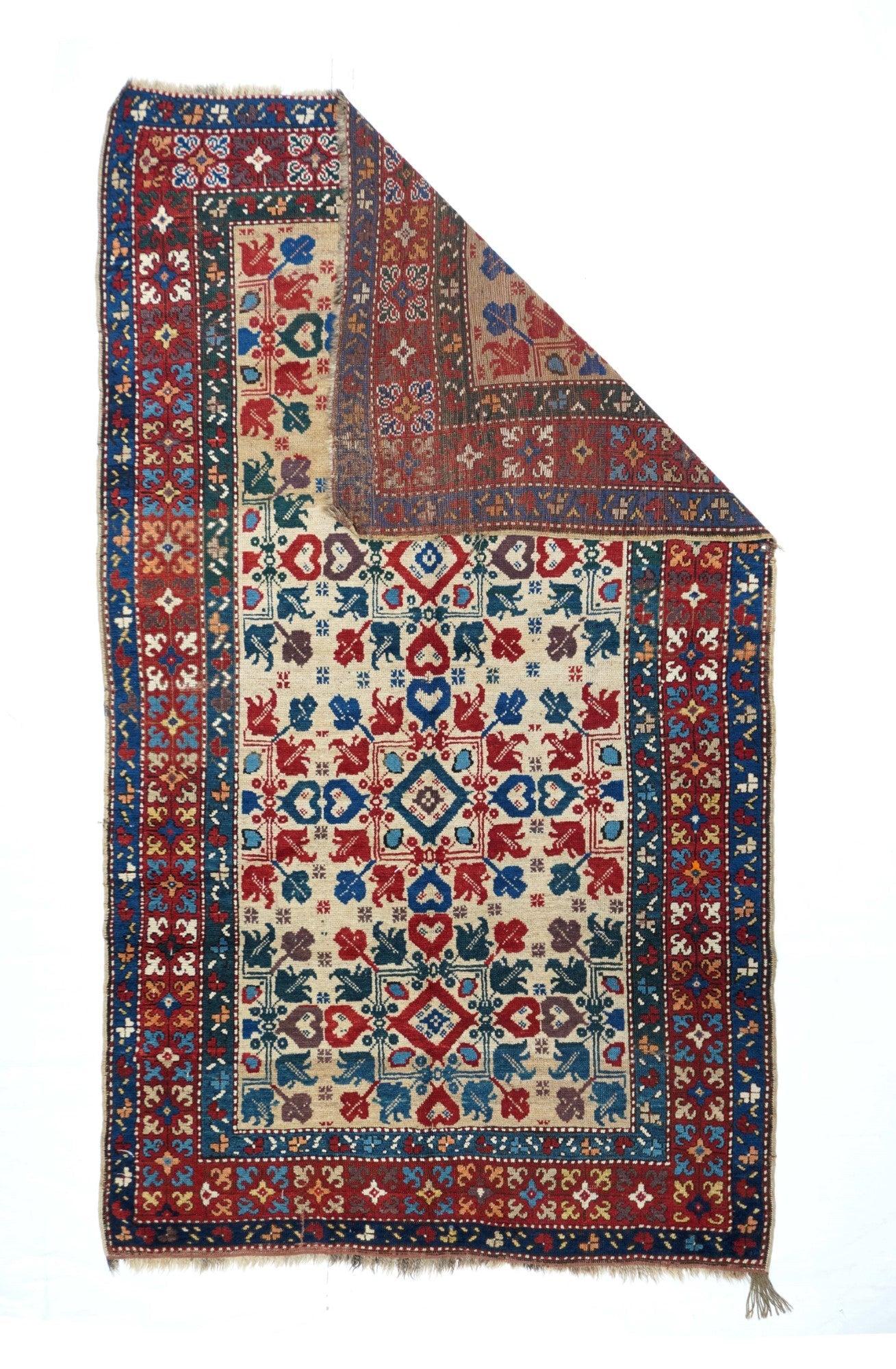 Antique Kazak Rug 4'4'' x 7'7''. Southern Caucasian, with a very unusual pattern of squares, diamonds, hearts and flowers, on a sandy ground, within a frame whose central stripe shows square floating modules of four radiating florets. Probably