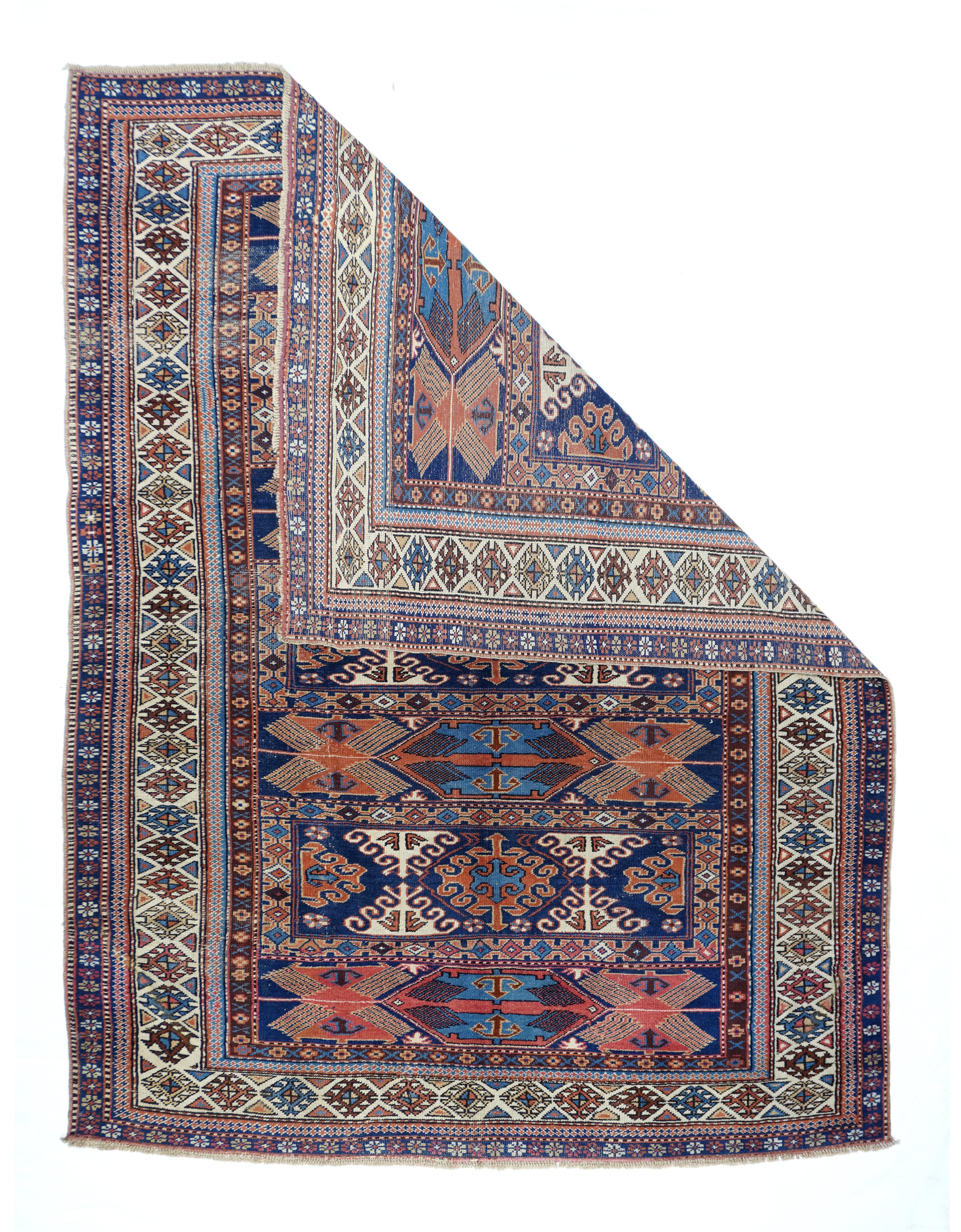 Antique Kazak rug 5'5'' x 7'5''. Antique Russian Kazak Wool on Wool 5'5'' x 7'5''. This very rare, probably east Caucasian/west Caspian, scatter in an enlarged soumak bag face design shows seven panels alternating with curly hooked lozenges and