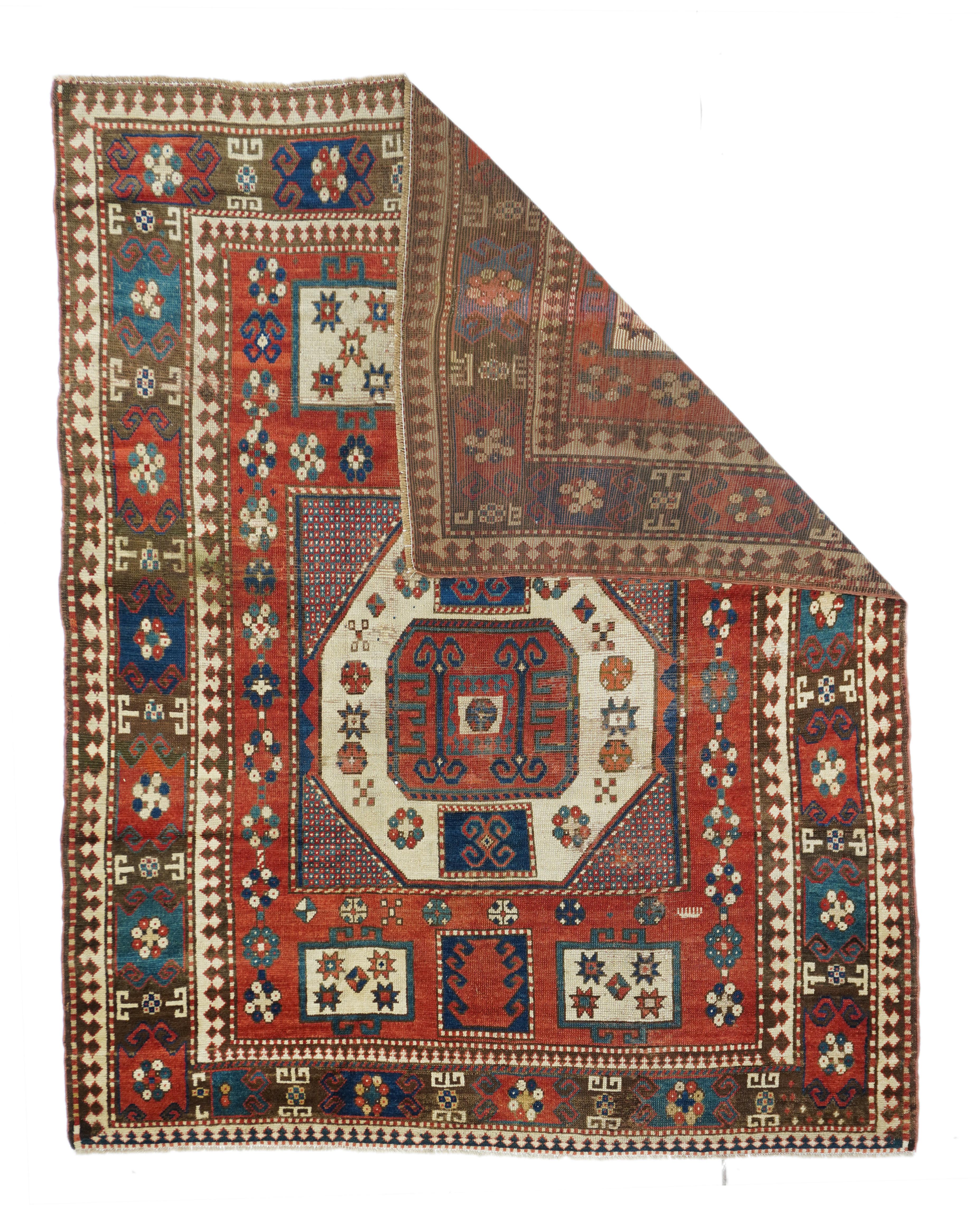 Antique Kazak Rug 5'7' ' x 7'4''. This amusingly stretched out SW Caucasian Armenian scatter show a tomato madder red field with a characteristic cream octagon with small chessboard mosaic corners. The weaver had extra loom space toward one end and