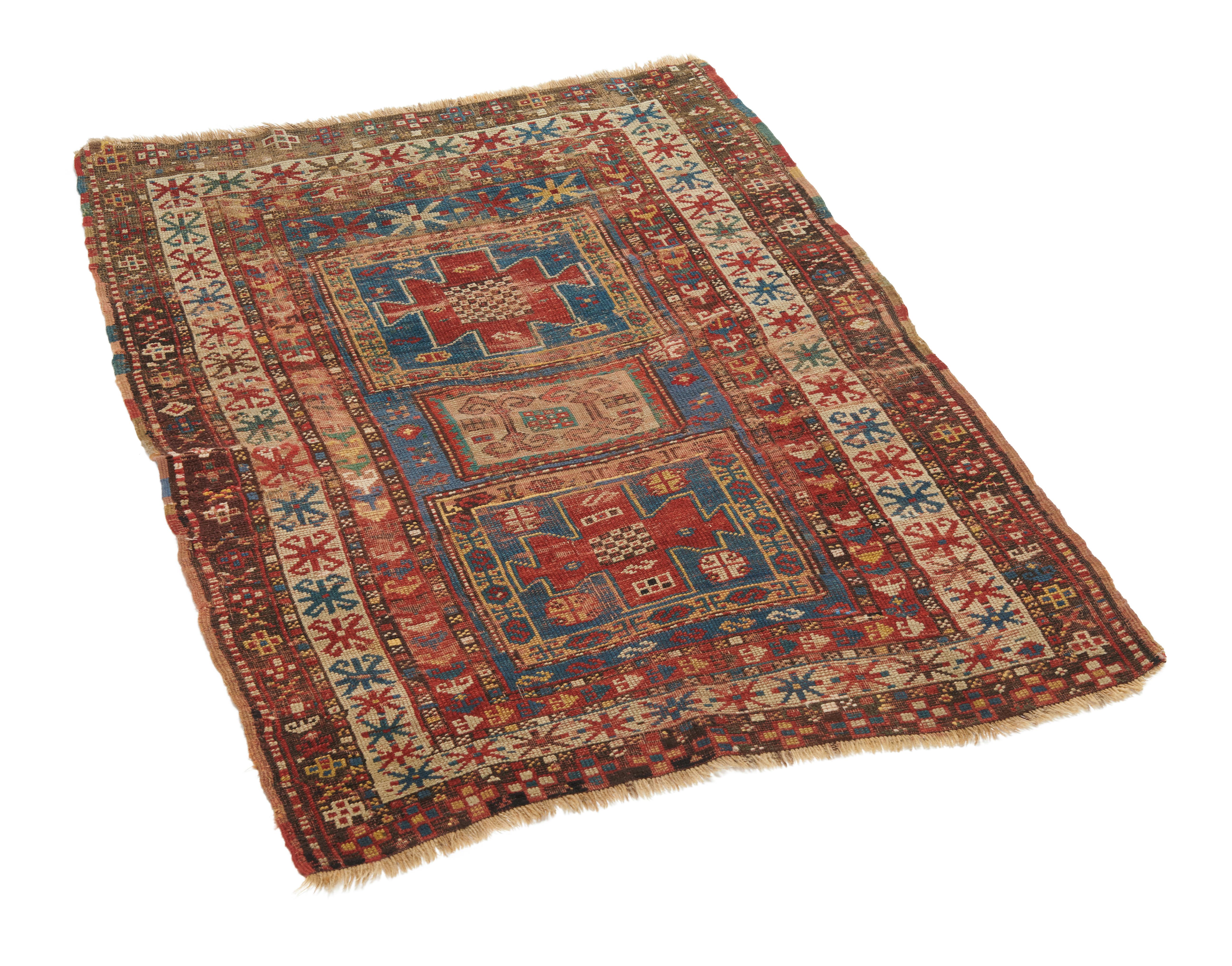 This wonderful Kazak rug's pattern element outlined in blue is a water basin of a formal garden. The balance of the field is served with single rows of petalled rosettes, adjacent to the inside border. 

Caucasus is an area that includes