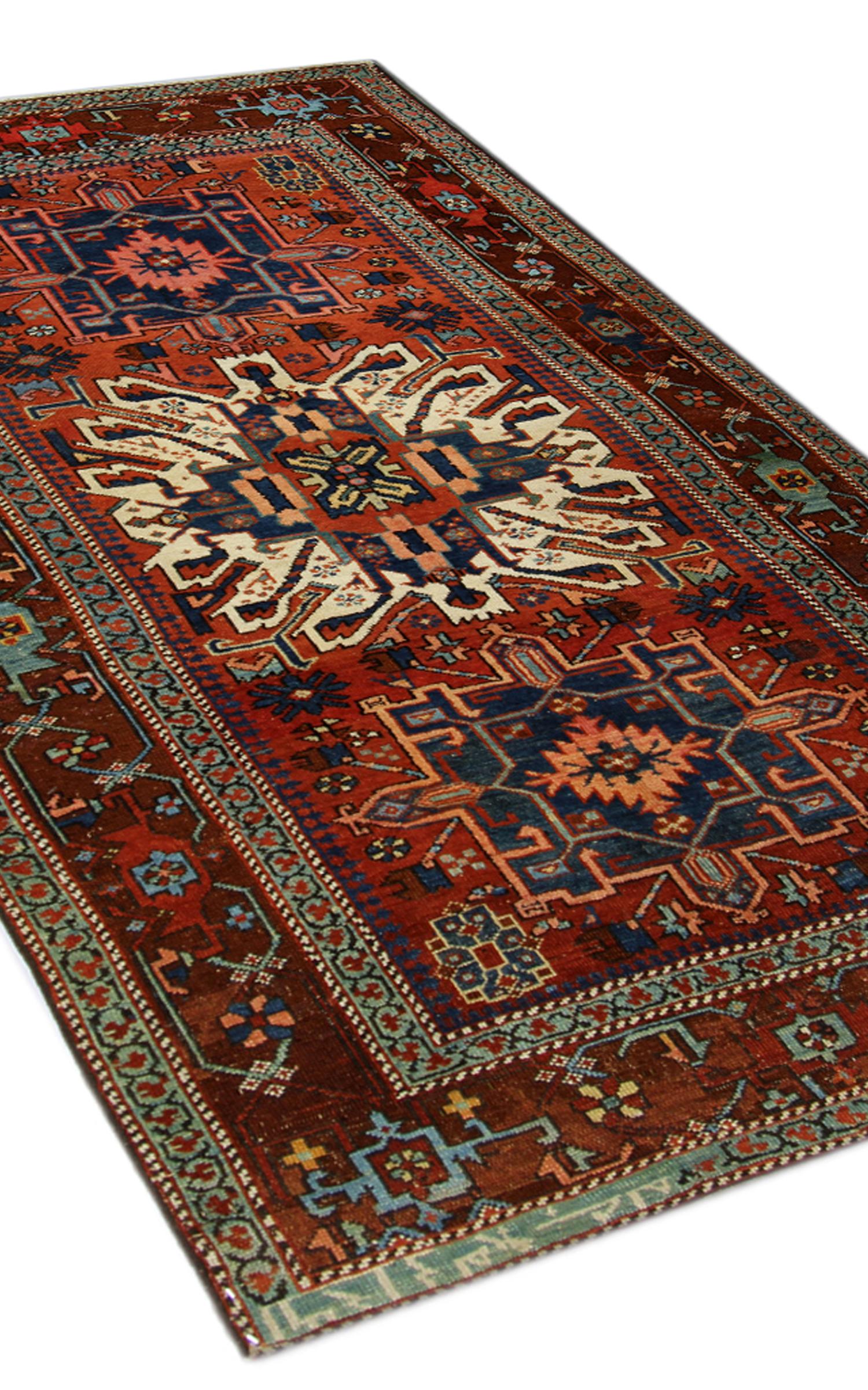 This beautiful wool rug is a fine example of a carpets from the 1890s. The design features three medallions woven through the centre on a field of orange-brown, the accents have been woven in ivory, blue and orange colours. Both the accents and the