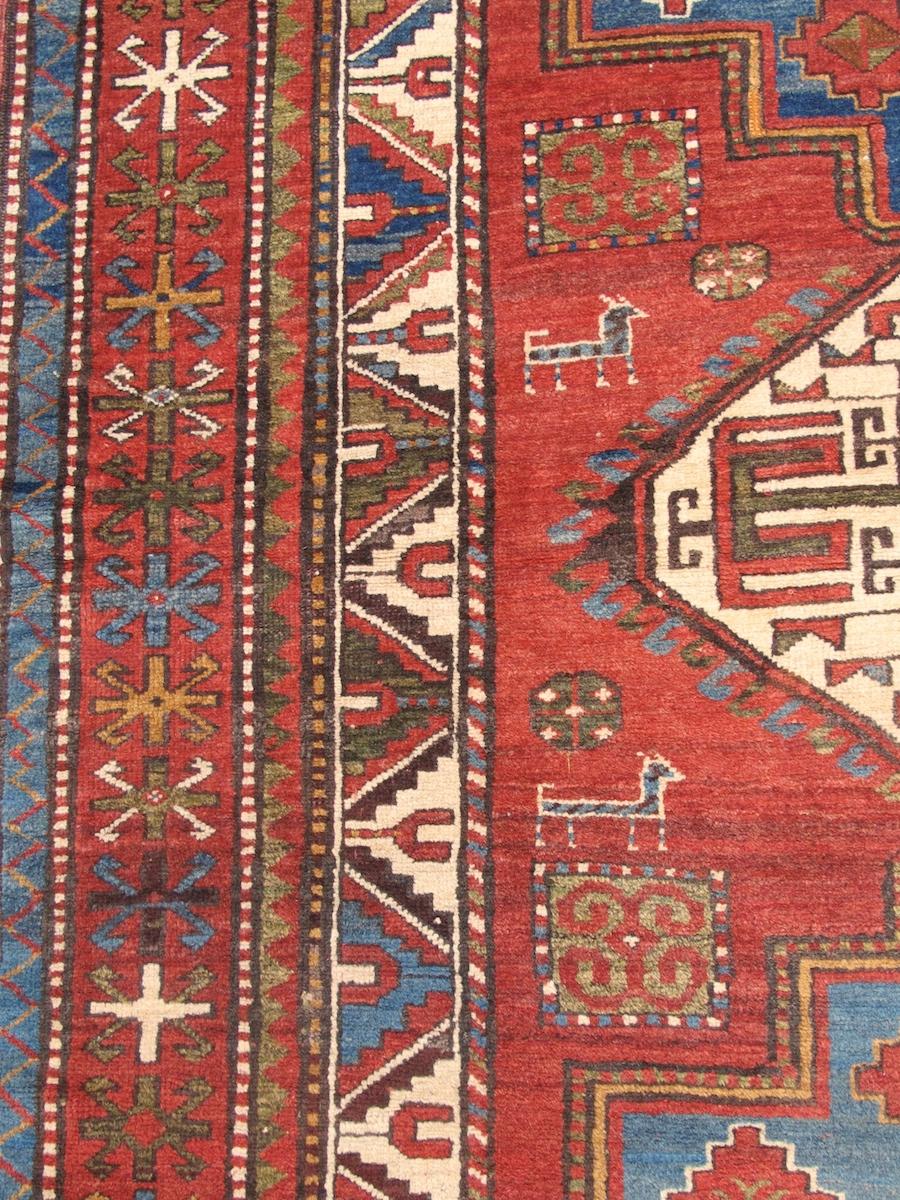 Antique Caucasian Kazak Rug, Late 19th Century

This classic Kazak was most probably woven in the Karabagh region of the South Caucasus, perhaps by Armenian weavers. A column of three large medallions are drawn against a madder red ground with a
