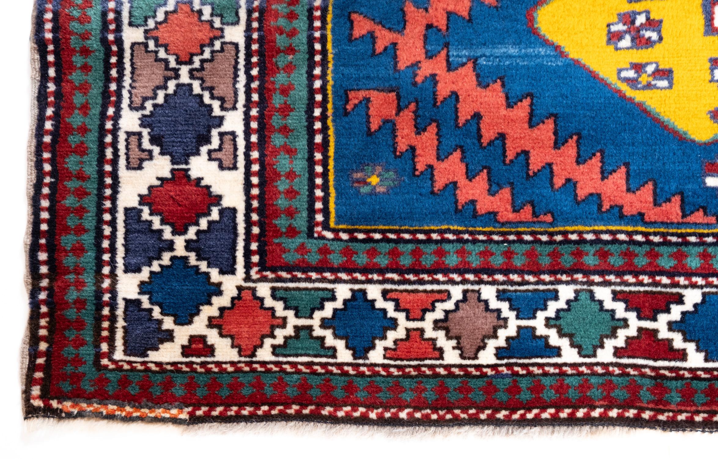 This is an antique Kazak Rug from the Caucasus region with nice color composition.

Kazak rugs have a strong folk influence on their design. They house big, bold, dominating geometric patterns on a subtle color backdrop, giving them an edge that