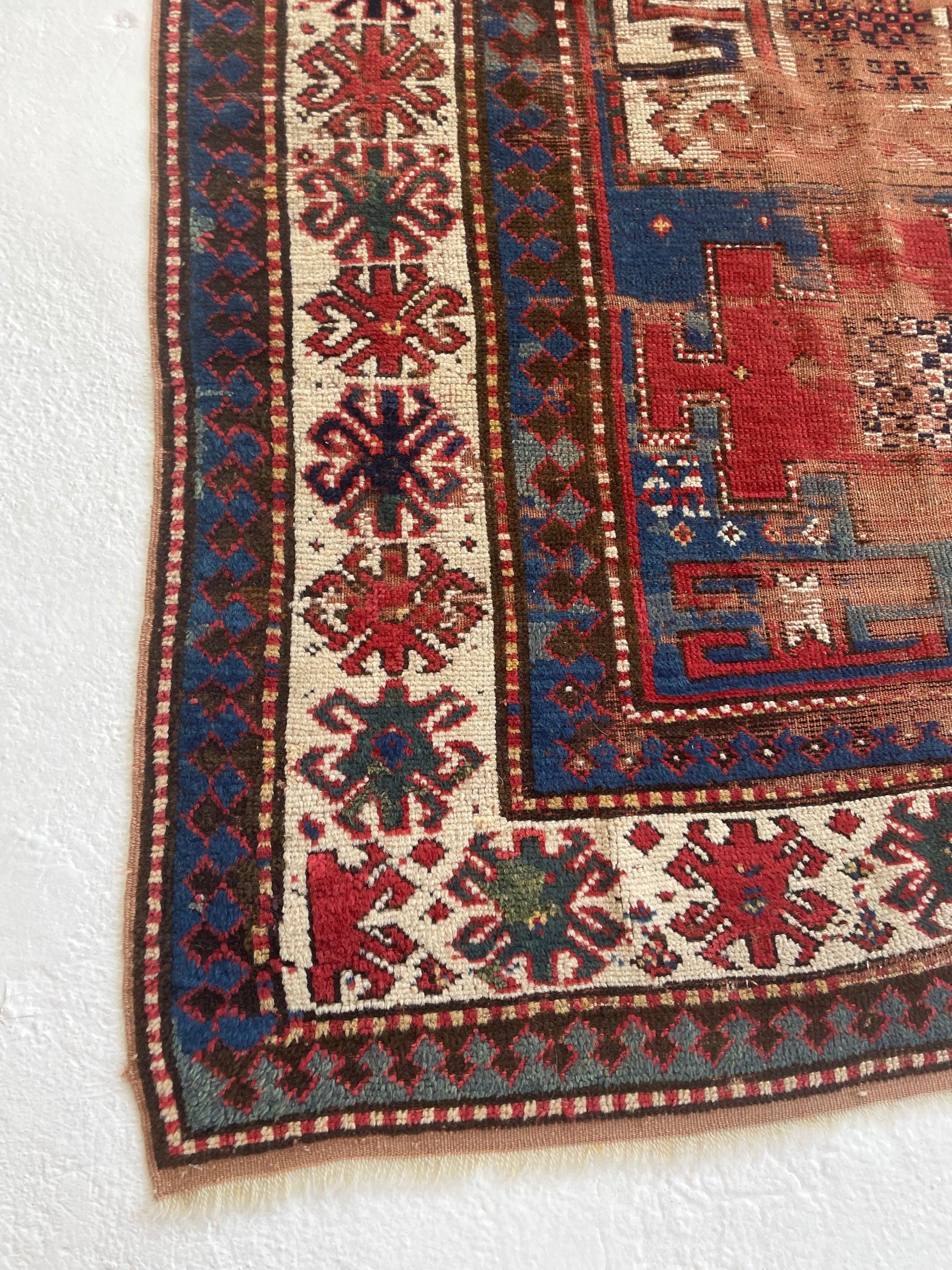 Handsome Antique Kazak Rug  Character-Rich with Iconic Fence of Protection Perimeter 

About: Old-world charm packed in this piece with an iconic fence perimeter and sensational color palette with charcoal, teals, wheat, 20 shades of blue, and more.