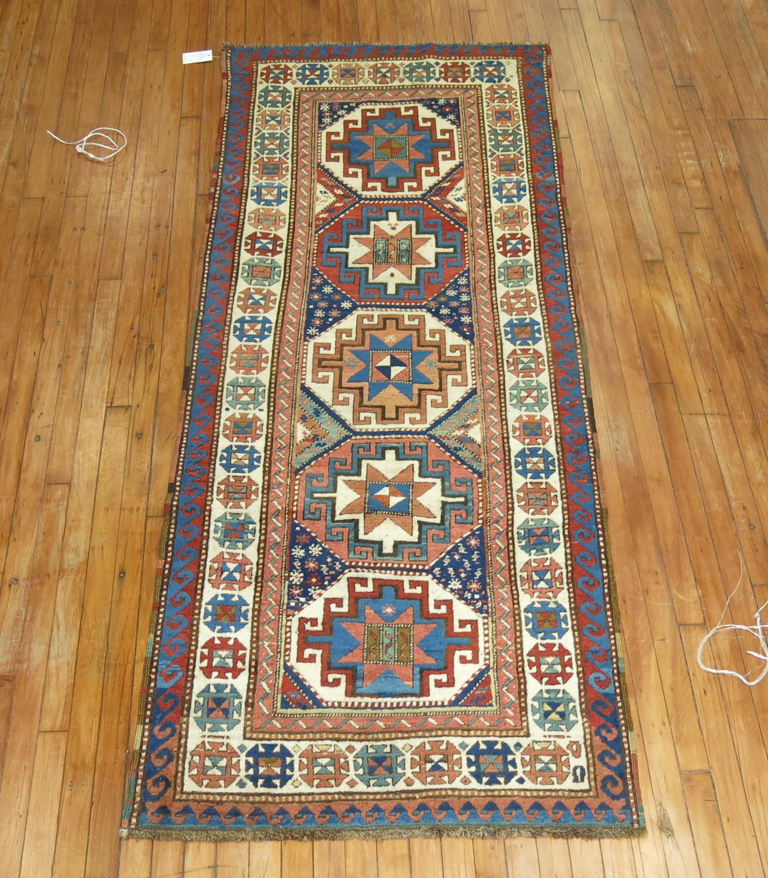 Rare size early 20th century Caucasian Kazak runner.

Known for their bold designs, harmonious colors and good-quality dyes, some of the most spectacular geometrically designed piled rugs found anywhere in the East originated in the Kazak area of