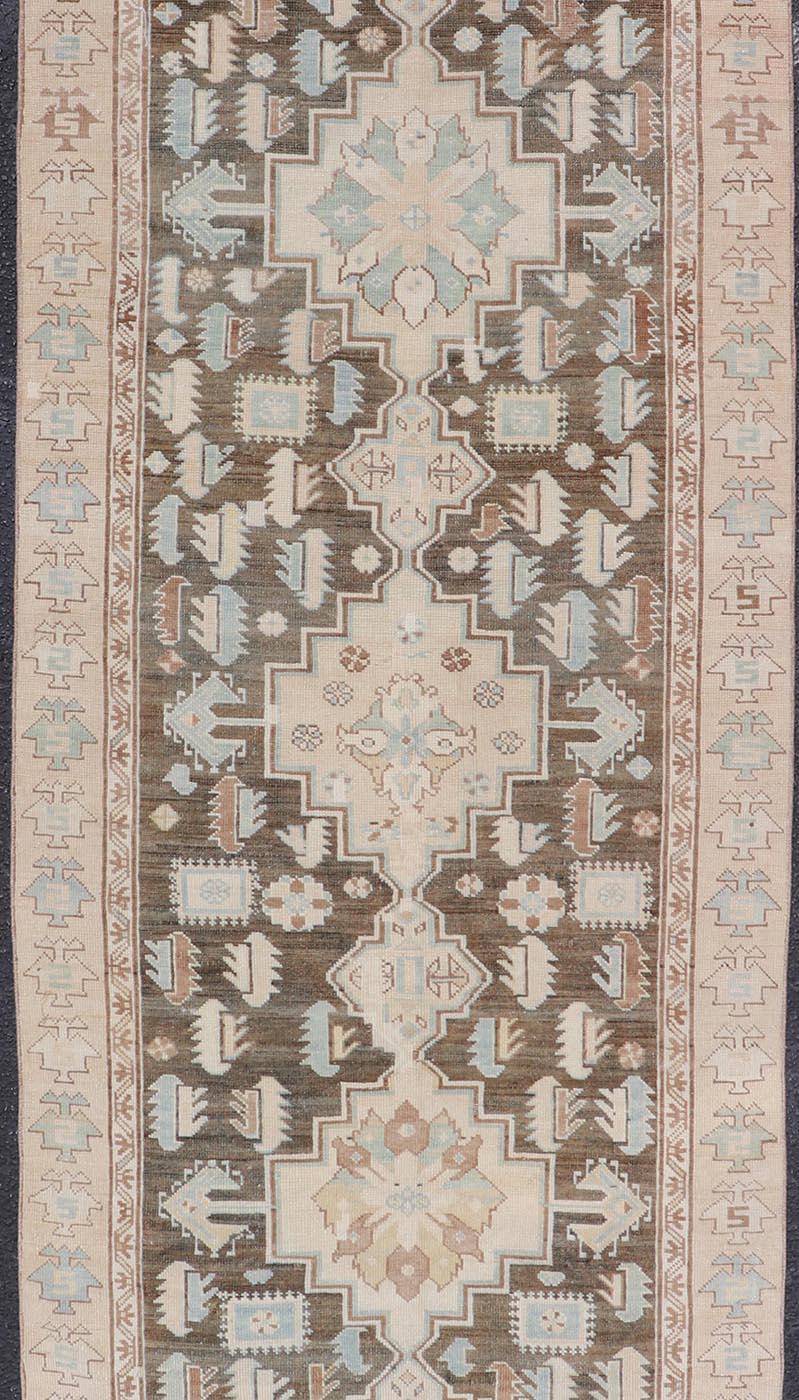 Antique Kazak runner with Geometric Design and Medallions On A Brown Field 
Country of Origin: Caucasus Type: Kazak Design: medallion, Sub-Geometric, Early 20th century, Keivan Woven Arts; rug S12-0519
Measures: 3'2 x 8'7 
This piece was