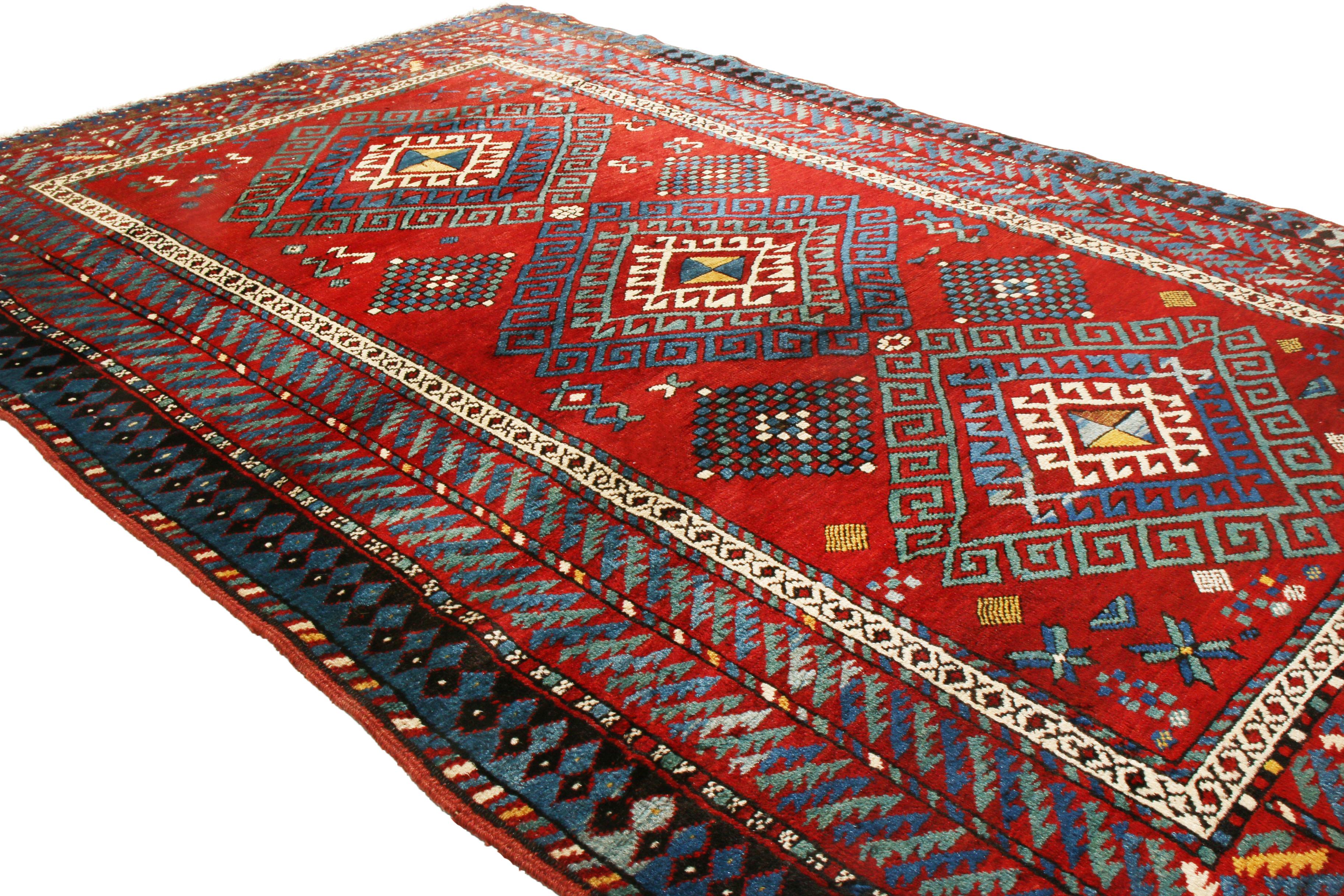 Originating from Russia between 1890-1900, this antique transitional Kazak rug features an emboldened series of Dyrnak guls among its rich and varied symbols throughout this all over field design. Hand knotted in high quality wool, the Dyrnak gul is