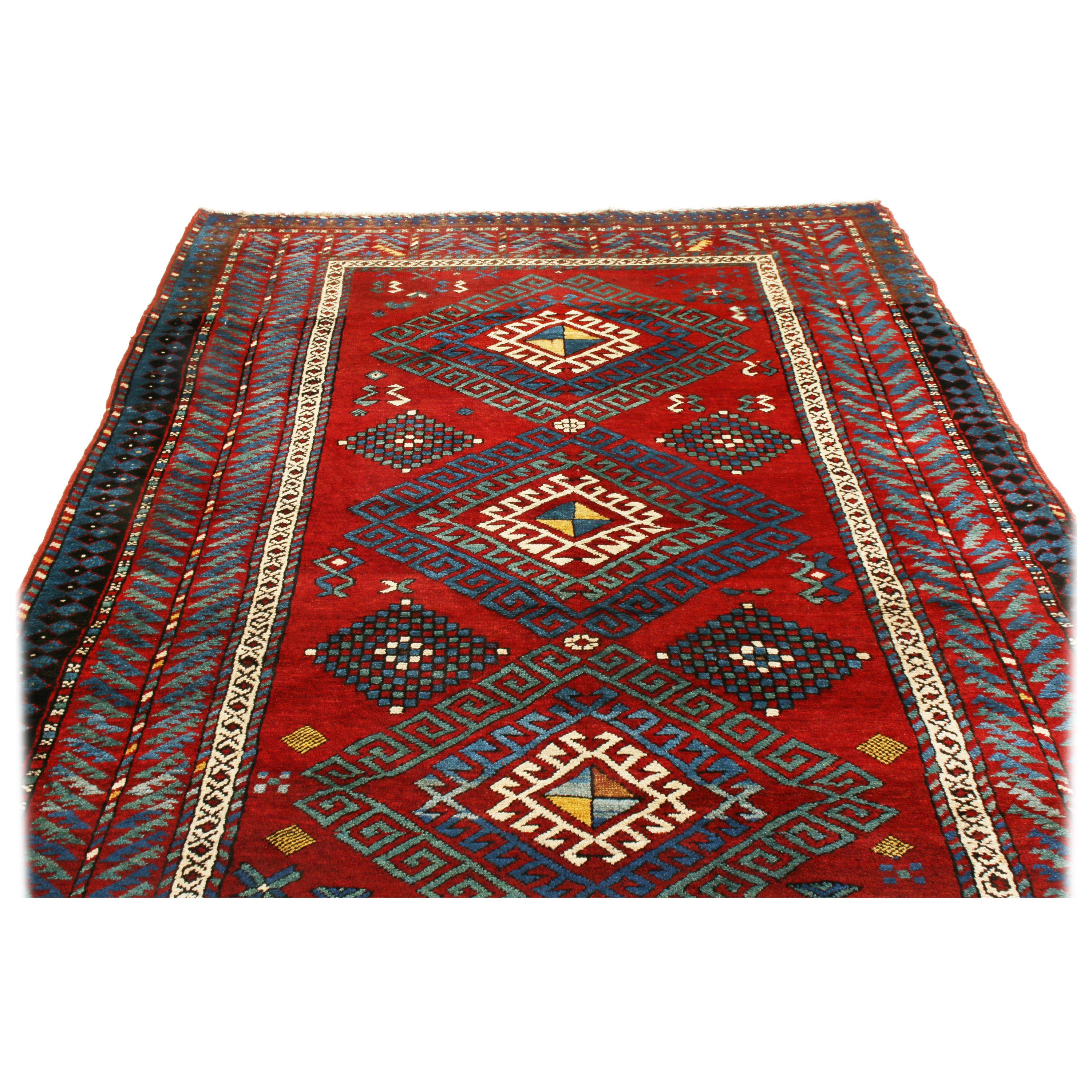 Antique Kazak Transitional Geometric Red and Blue Wool Rug with Dyrnak Guls