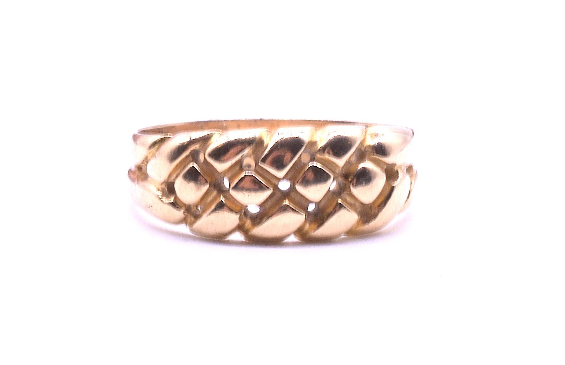 Hallmarked Birmingham for 1896 and crafted in 18K yellow gold, our antique keeper ring has three rows of braided gold work. There are small air holes on the underside allowing for the release of water when the ring gets wet. This ring can be worn