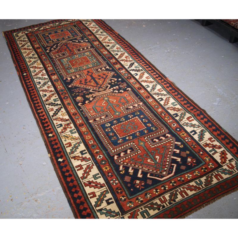 Antique Kelardasht runner, of a scarce traditional design.

This runner was woven by a small community of Karabagh Kurds who settled in the Mazandaran province in the late 19th century. The design with two elongated medallions on a dark indigo