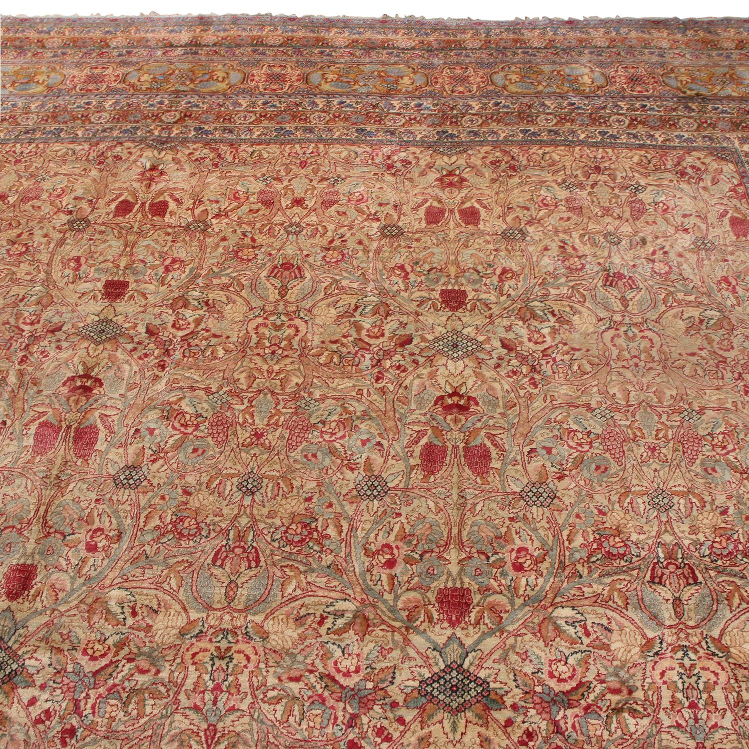 Hailing from Persia between 1890-1900, this antique Kerman rug is named for its origins in one of the most acclaimed provinces of Persian rug making spanning centuries. Enjoying hand-knotted high-quality wool and natural dyes in a rich complementary