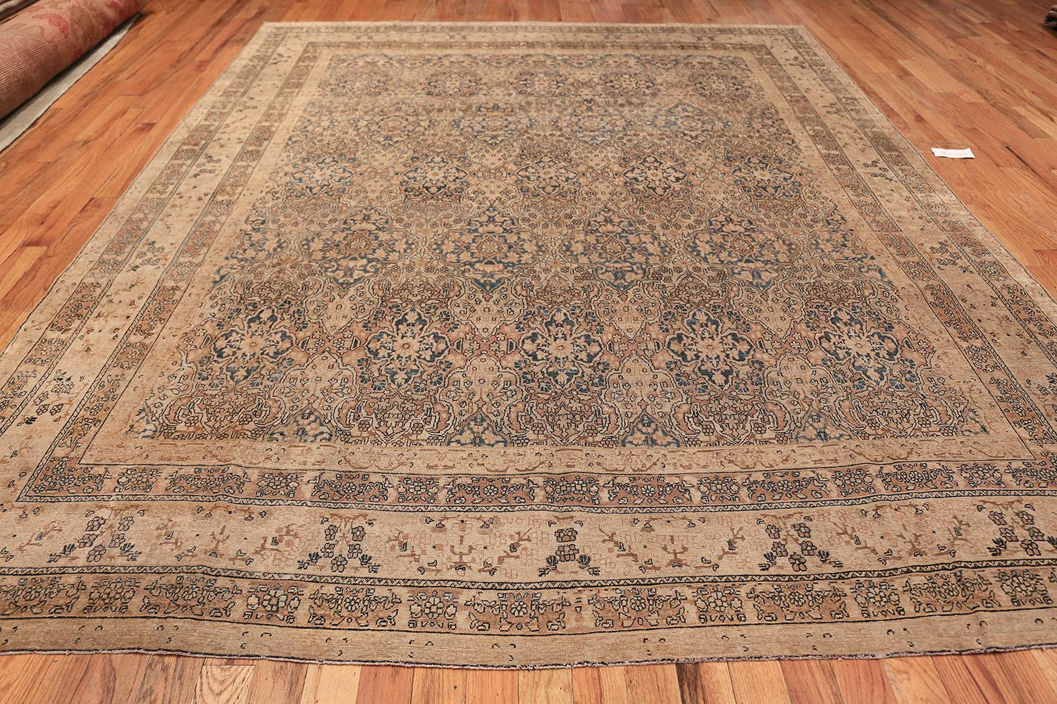 Woven in the Kerman style, this elegant carpet features a tessellating latticework pattern woven in a stunning combination of oxidized Persian blue, camel and golden-brown.

Beautiful Decorative and Finely Woven Antique Room Size Persian Kerman