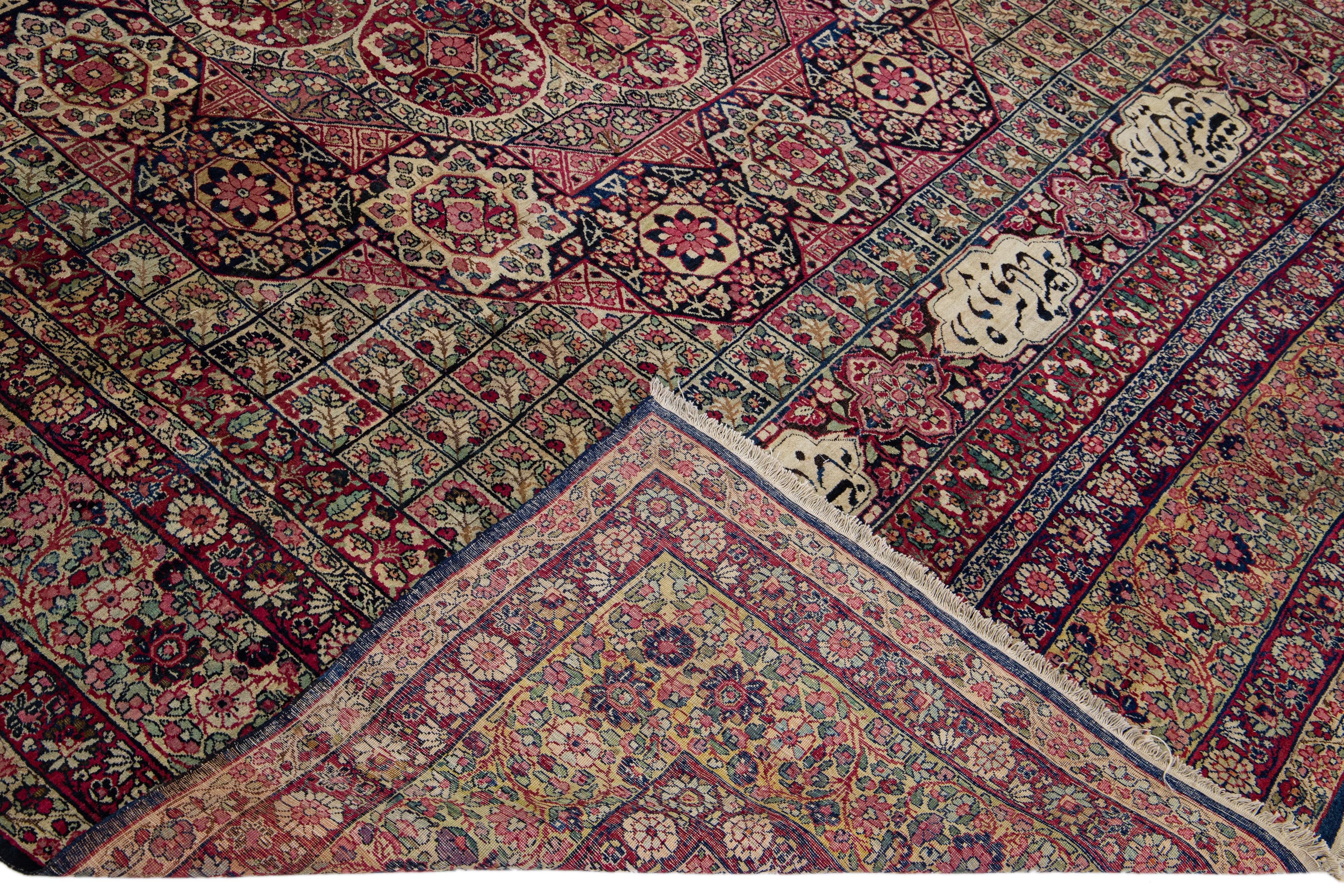 Beautiful antique Kerman hand-knotted wool rug with a tan field. This Kerman rug has pink, red, and blue accents in a gorgeous all-over floral pattern design.

This rug measures: 8'10