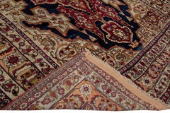 Antique Kerman Handmade Red and Blue Floral Medallion Motif Wool Rug
