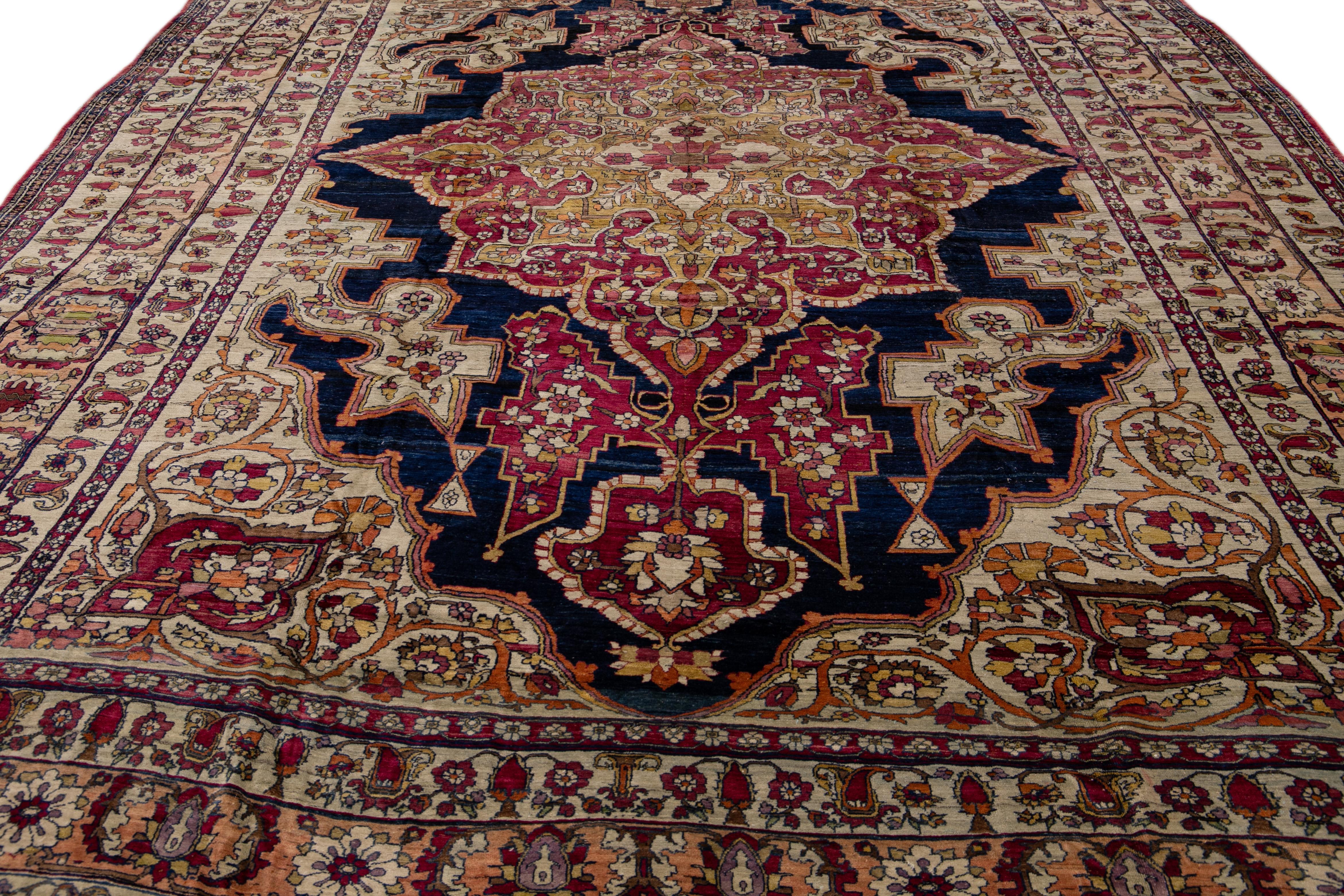 Islamic Antique Kerman Handmade Red and Blue Floral Medallion Motif Wool Rug For Sale