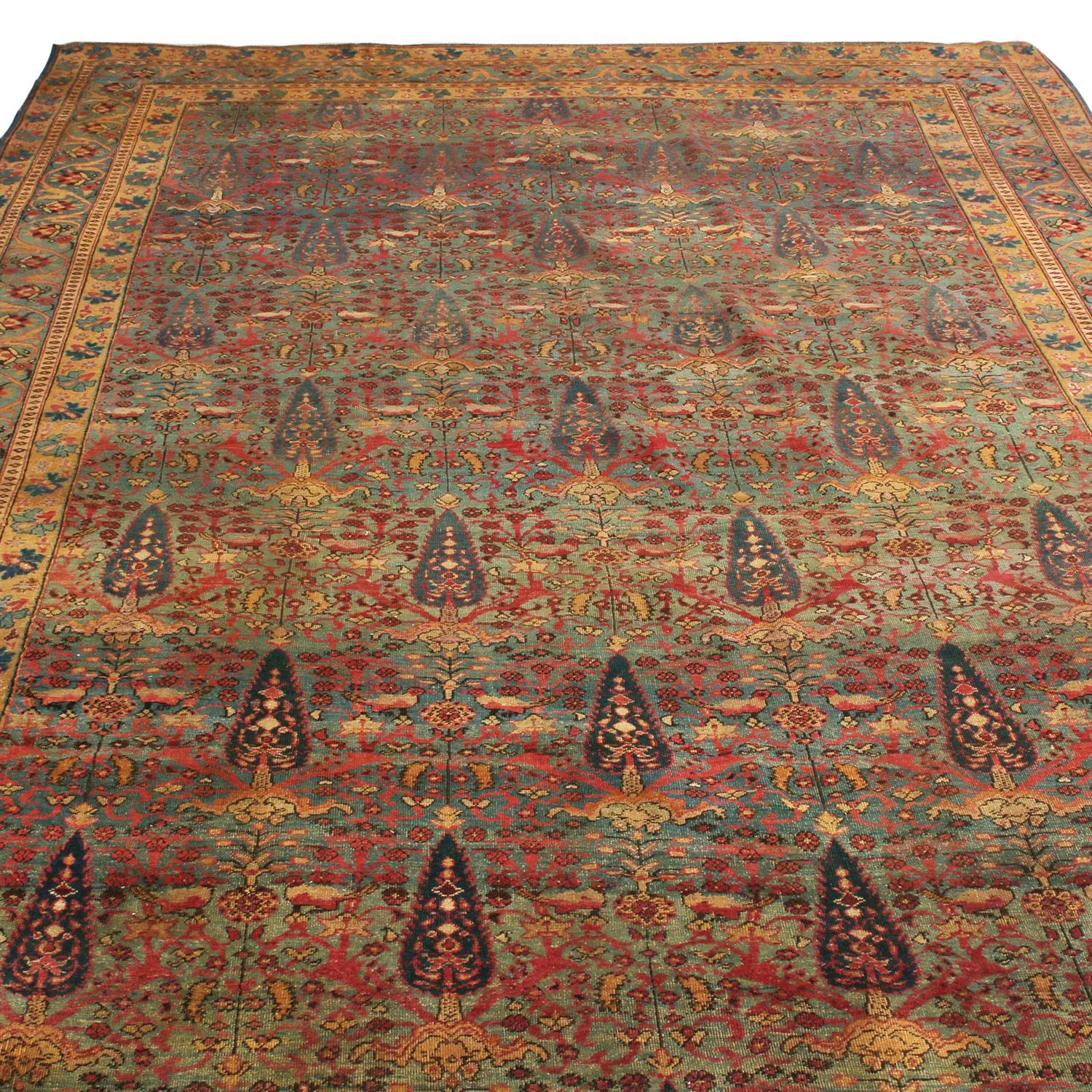Originating from Persia between 1890-1900, this antique Kerman Lavar Persian rug hails from a distinguished family crafted in one of the most famous provinces of rug making. The field presents a once-acclaimed Persian motif representing the Cypress
