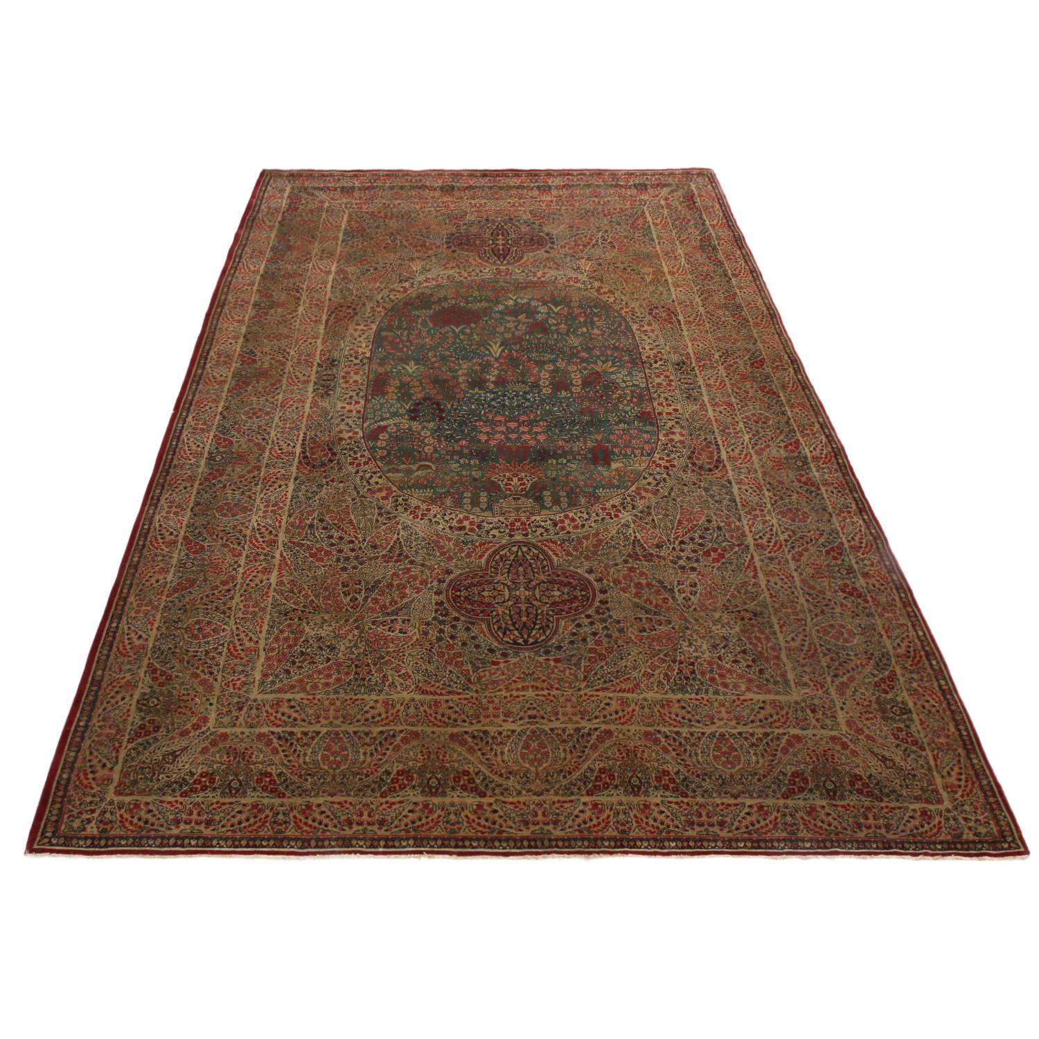 Originating from Persia in 1890, this antique Kerman Lavar Persian rug hails from one of the most famed cities of Persian rug making, enjoying a mille field pattern with fine and lively burgundy red, frost blue, purple, green and silver-beige