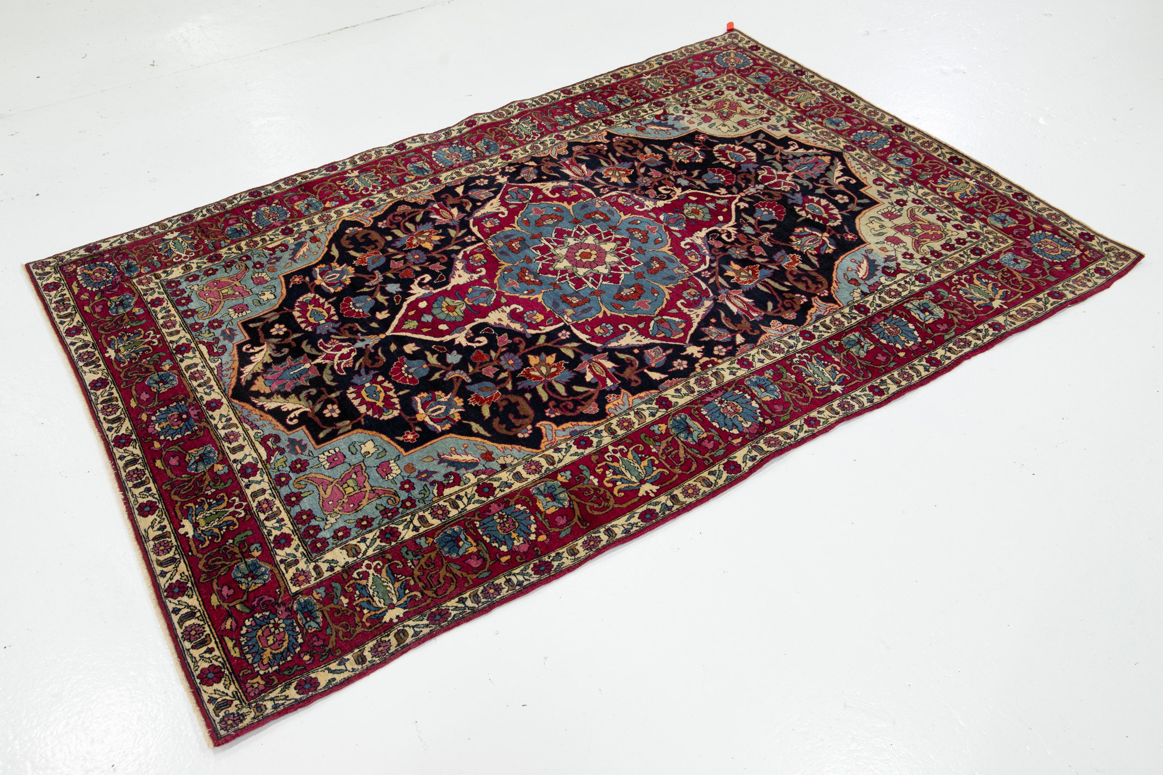 Kirman Antique Kerman Persian Dark Blue Wool Rug with a Medallion Floral Design For Sale