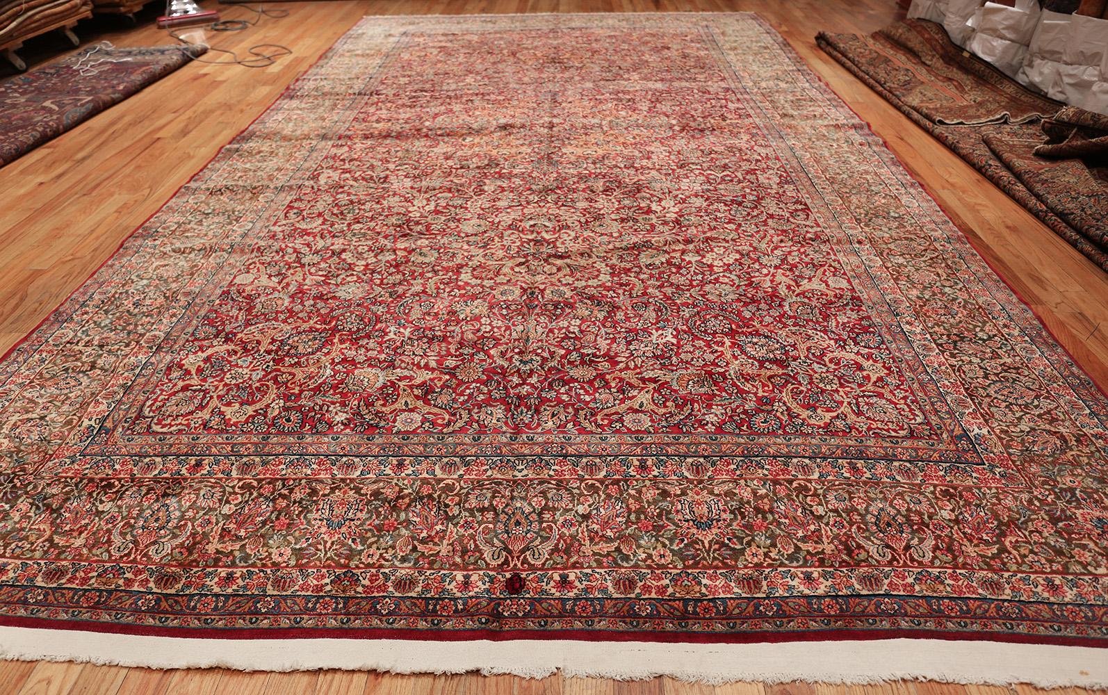 Antique Kerman, country of origin: Persia, date: circa late 19th century. Size: 9 ft 9 in x 17 ft 3 in (2.97 m x 5.26 m)

A richly articulated all-over pattern of vines and flowers sprawls lushly across the field of this sumptuous antique Persian