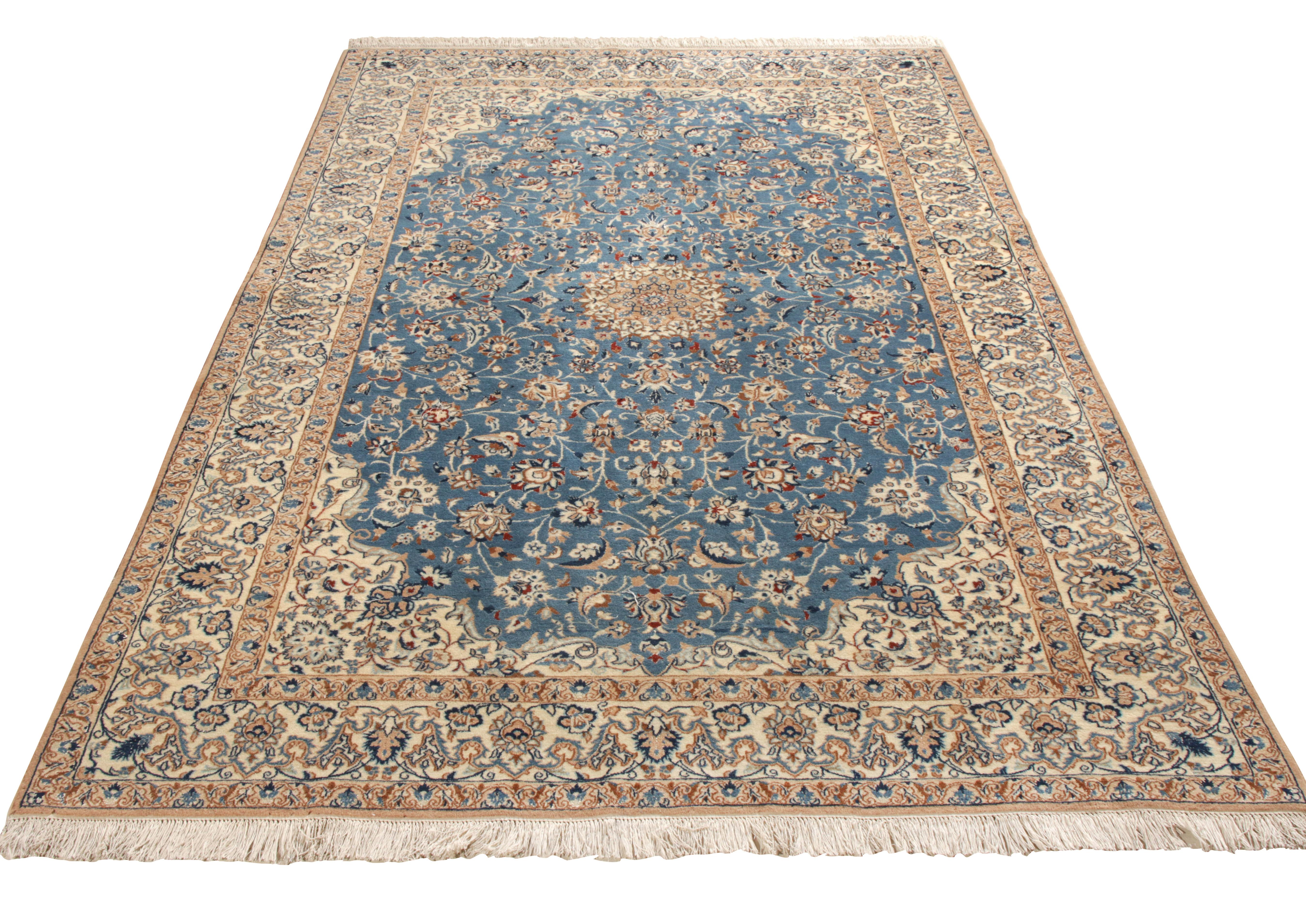 Hand-knotted in gorgeous tones of blue and beige, a mid-century 5x8 Naiin Persian rug entering Rug & Kilim’s Antique & Vintage collection. Hailing from the 1950s, this piece dwells in the reverie of classic medallion patterns in a lush blue