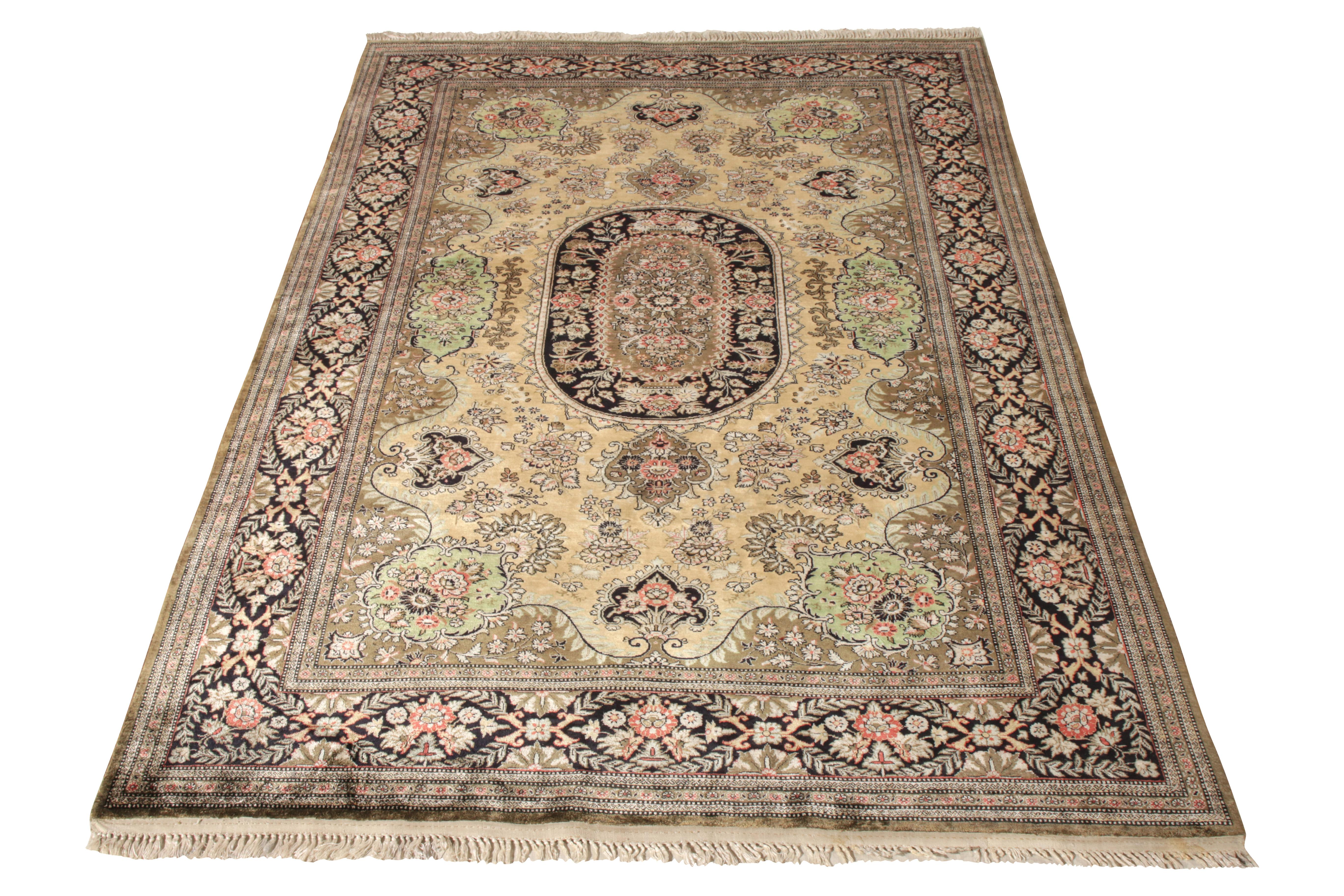 A hand-knotted silk Qum rug dated back to the 1950s joining Rug & Kilim’s Antique & Vintage collection. A classic 4x7 piece carrying a mesmerising medallion pattern enveloped in a rich all over floral design. The rug flourishes in rich tones of
