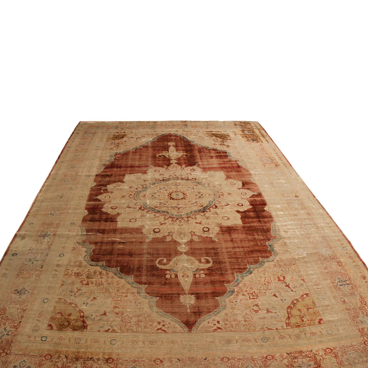 Hand knotted in luminous, high-quality silk originating from Persia in 1890, this antique Kerman Persian rug hails from one of the most widely recognized cities of antique and vintage Persian carpet making. Celebrating a simple but elegant field