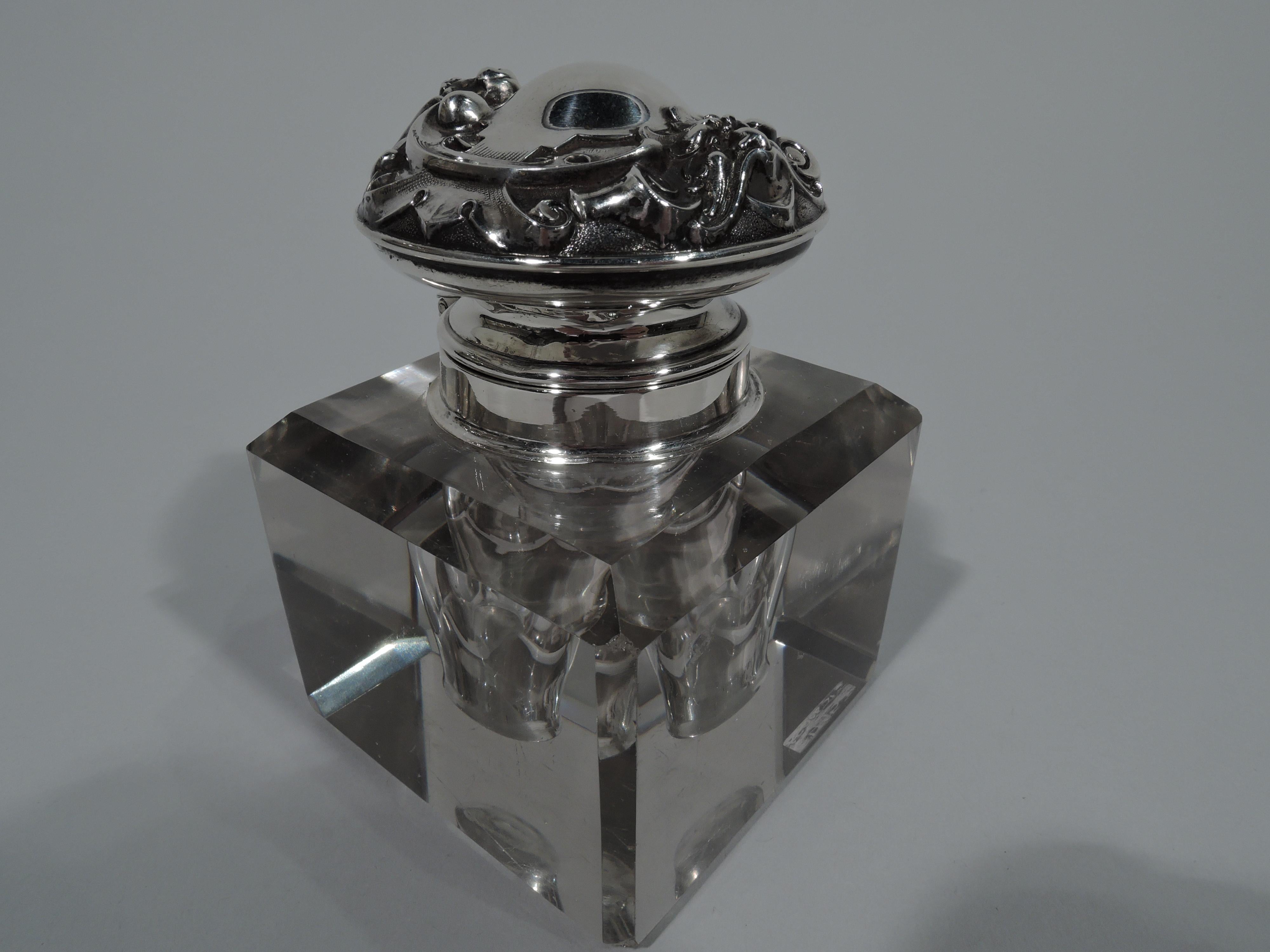 Edwardian sterling silver and cut-glass inkwell. Made by William B. Kerr in Newark, circa 1900. Clear glass rectangular block with faceted shoulder and corners. Ovoid well with short neck in sterling silver collar with hinged cover. Cover top has