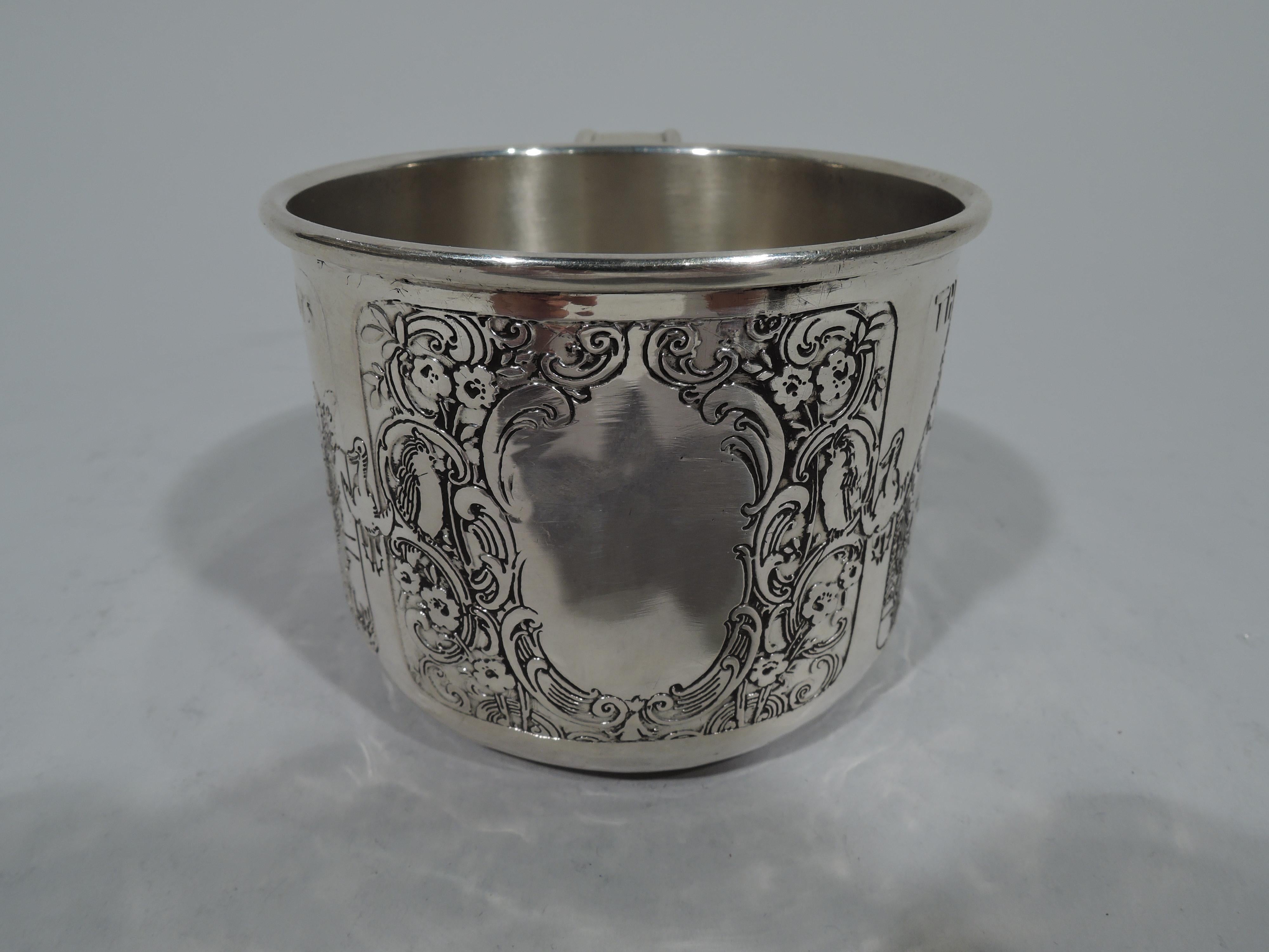 Edwardian sterling silver baby cup. Made by Kerr in Newark, circa 1910. Straight sides and tapering c-scroll ribbon handle. Acid-etched rhyme characters: Puss in Boots, two of the three Bears, and a sheep less Bo Beep. Also scrolled cartouche