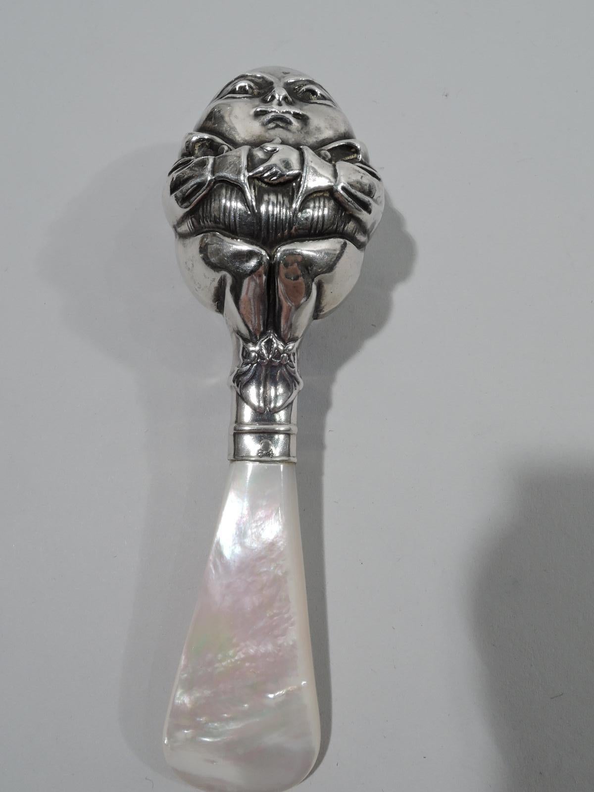 Turn-of-the-century sterling silver and mother of pearl nursery rhyme rattle. Made by William B. Kerr in Newark. Sterling silver double-sided egg-shaped figure of Humpty Dumpty with arms stretched across belly and squatting on tapering