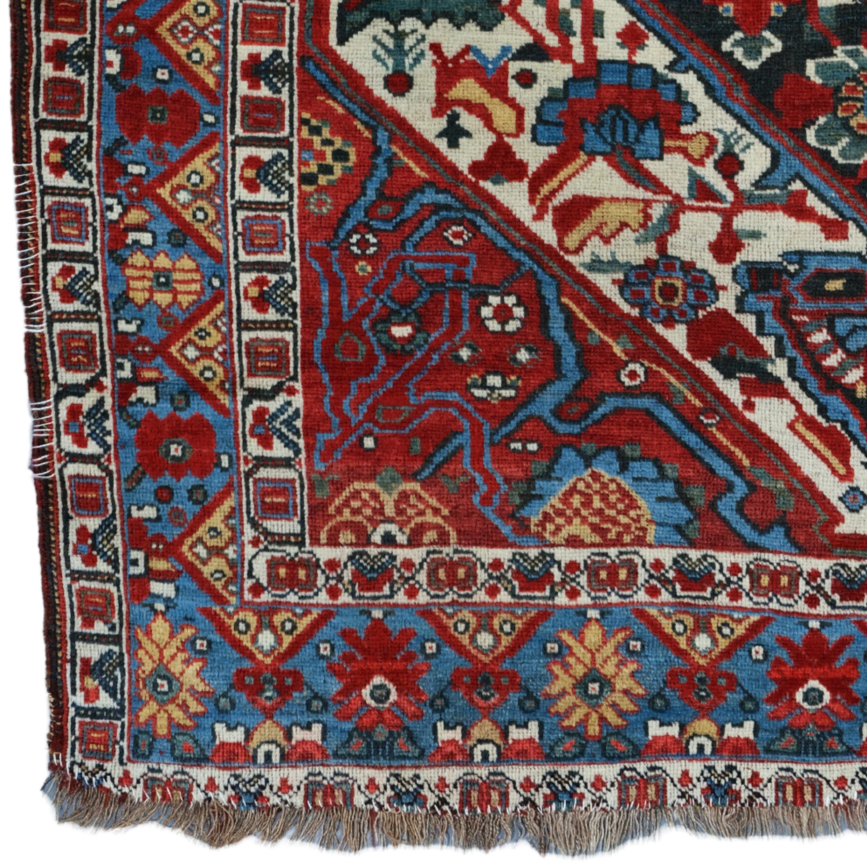 This exquisite 19th-century Khamseh carpet is an example of the most exquisite craftsmanship of its period. It adds nobility to any space with its rich history and sophisticated design. Vibrant red and golden motifs embroidered on a dark blue