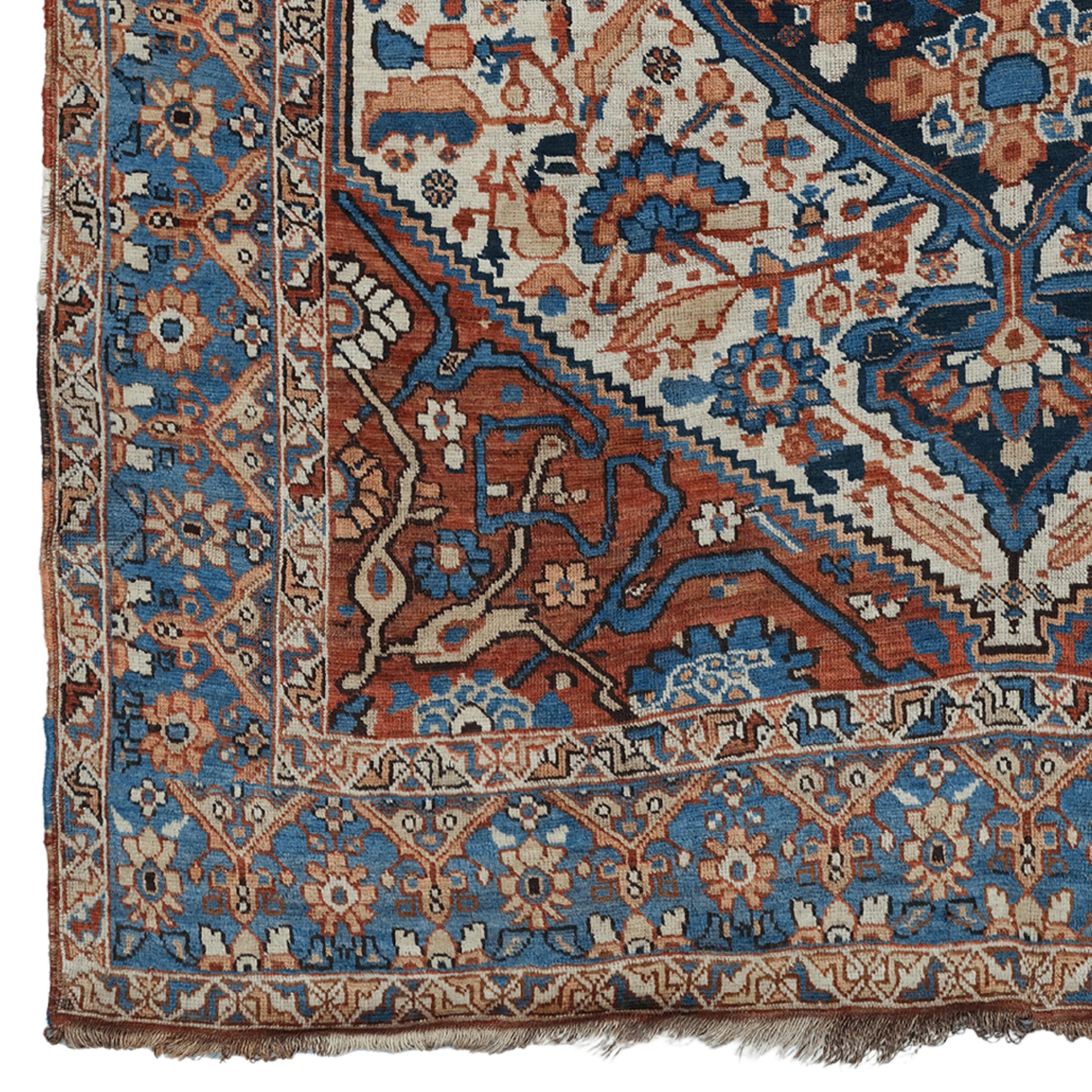 This exquisite antique Khamseh rug is a work of art from the late 19th century. This piece, which draws attention with its rich color palette and complex patterns, has a feature that will enrich the atmosphere of any space. Wool material is known