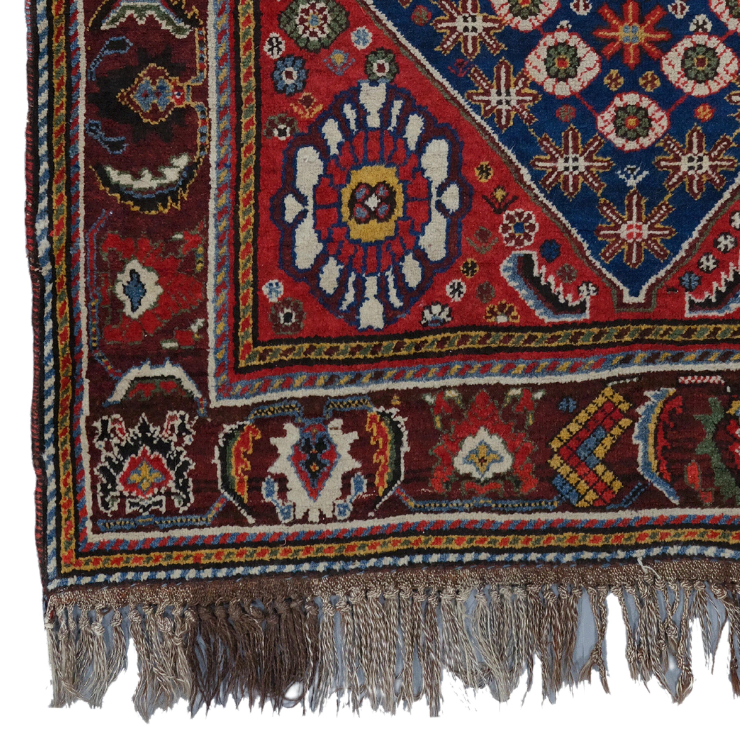 Antique Khamseh Rug  Antique Rugs
Late 19th Century Khamseh Rug
Size: 135×220 cm  4,42x7,21 Ft

Take a step-by-step journey into history with this elegant 19th-century antique khamseh rug. Its rich color palette and intricate patterns showcase the